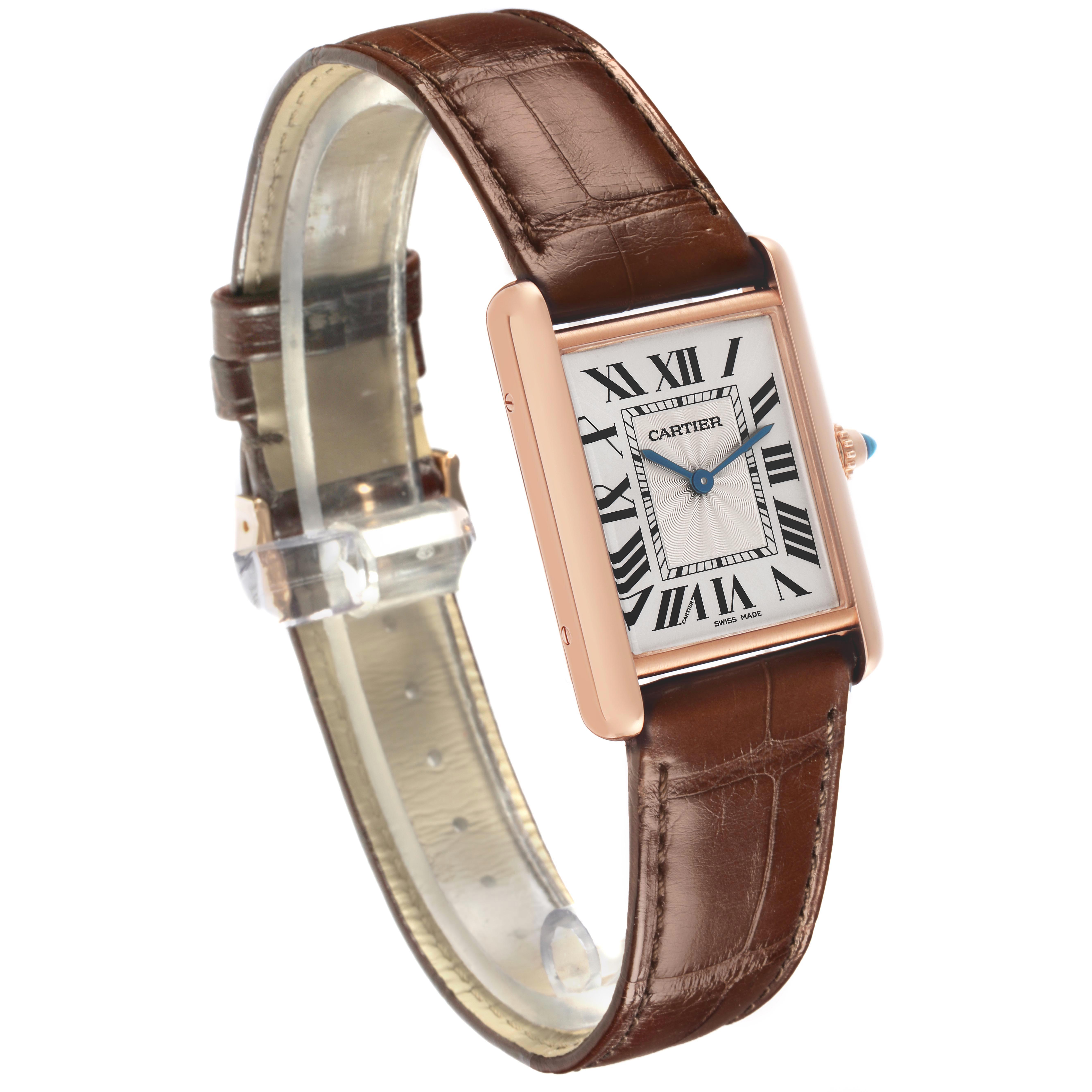 The Cartier Tank Louis WGTA0011 Men's Rose Gold Silver Dial WGTA0011 Men's Rose Gold Silver Dial watch is shown at an angle, displaying its face, casing, crown, and brown leather strap.