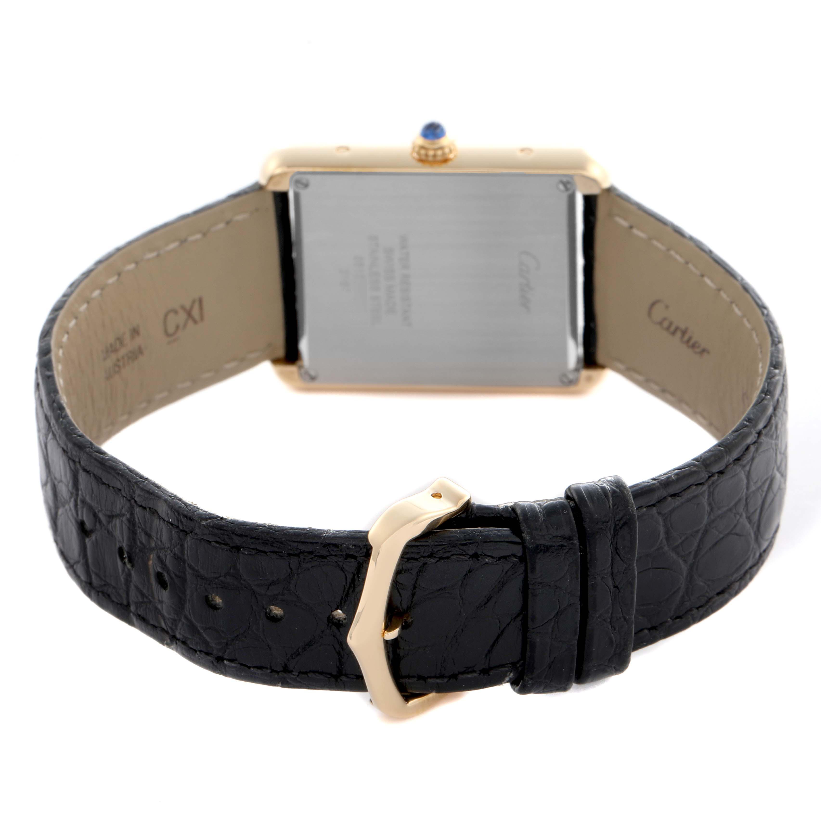 The Cartier Tank Solo W5200004 Men
s Steel and Gold (two tone) Silver Dial W5200004 Men
s Steel and Gold (two tone) Silver Dial watch is shown from the back, displaying the leather strap and case back with inscriptions.