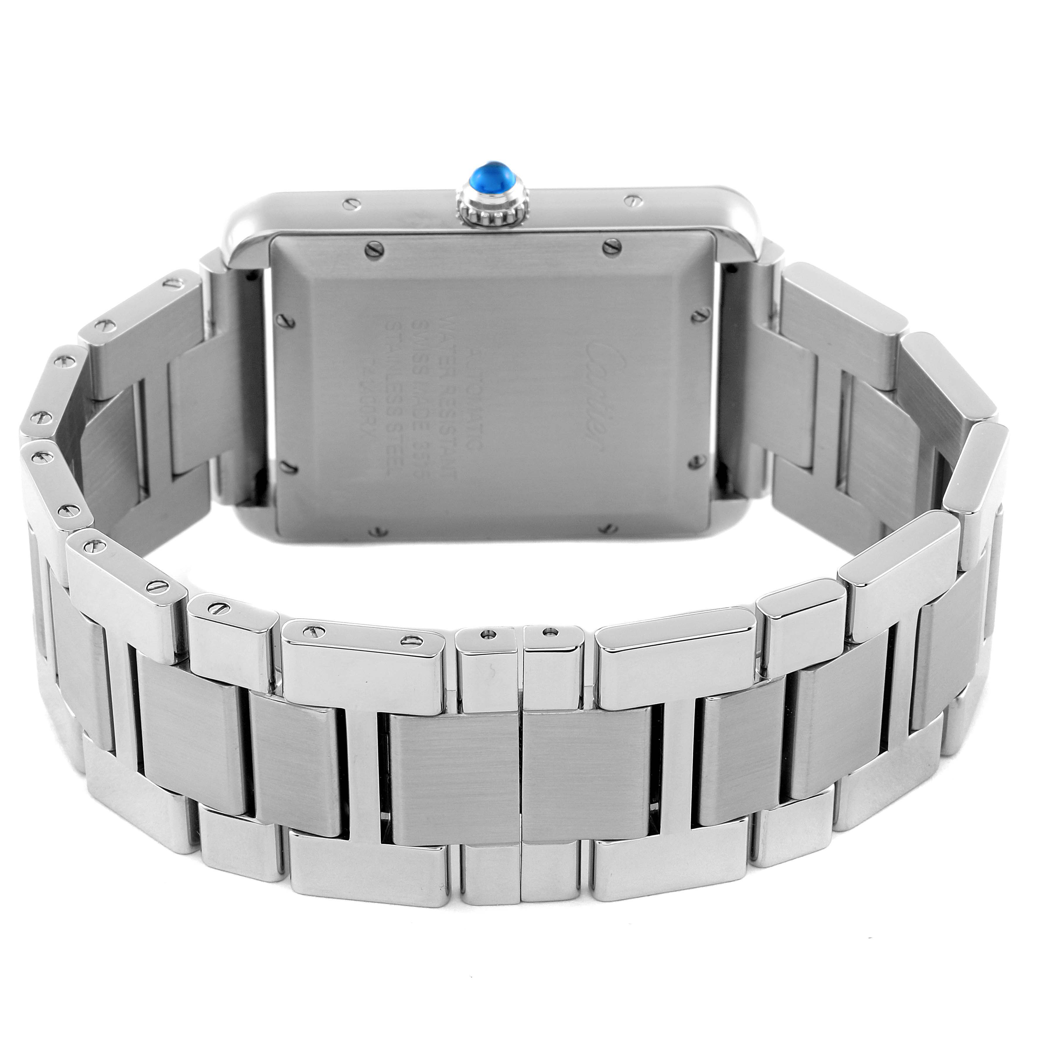The image shows the back of the Cartier Tank Solo W5200028 Men's Stainless Steel Silver Dial W5200028 Men's Stainless Steel Silver Dial watch and its stainless steel bracelet, including the crown with a blue gemstone.