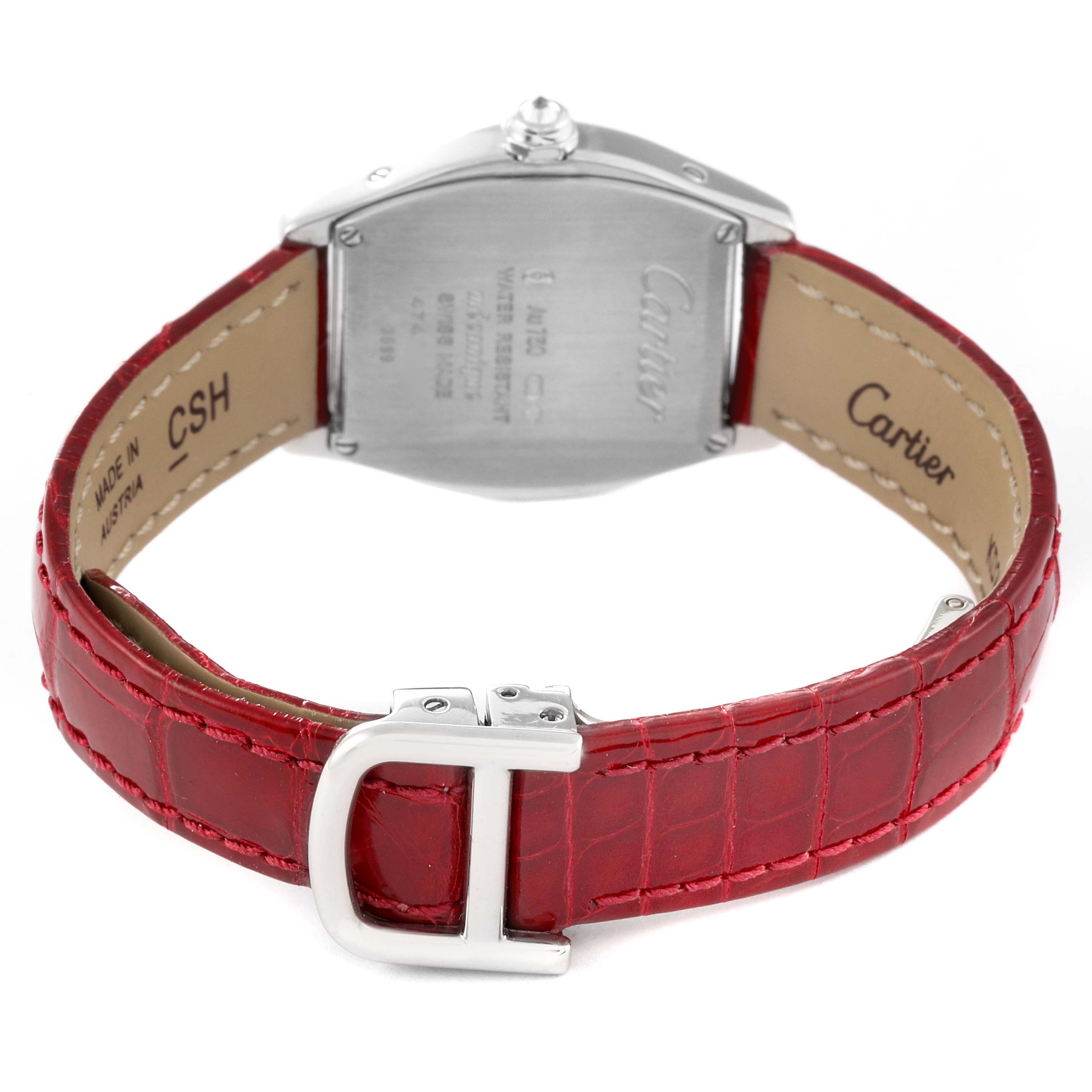 The Cartier Tortue WA501007 Women's White Gold Silver Dial watch is shown from the back, highlighting the case back, crown, and red leather strap with a buckle.