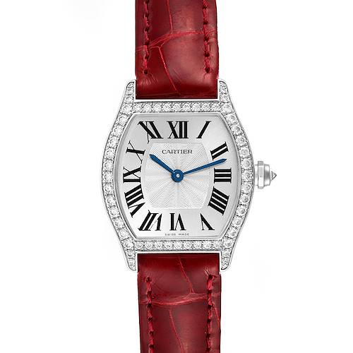The Cartier Tortue WA501007 Women's White Gold Silver Dial watch is shown from a top view, highlighting its diamond-studded bezel, Roman numeral dial, and red leather strap.