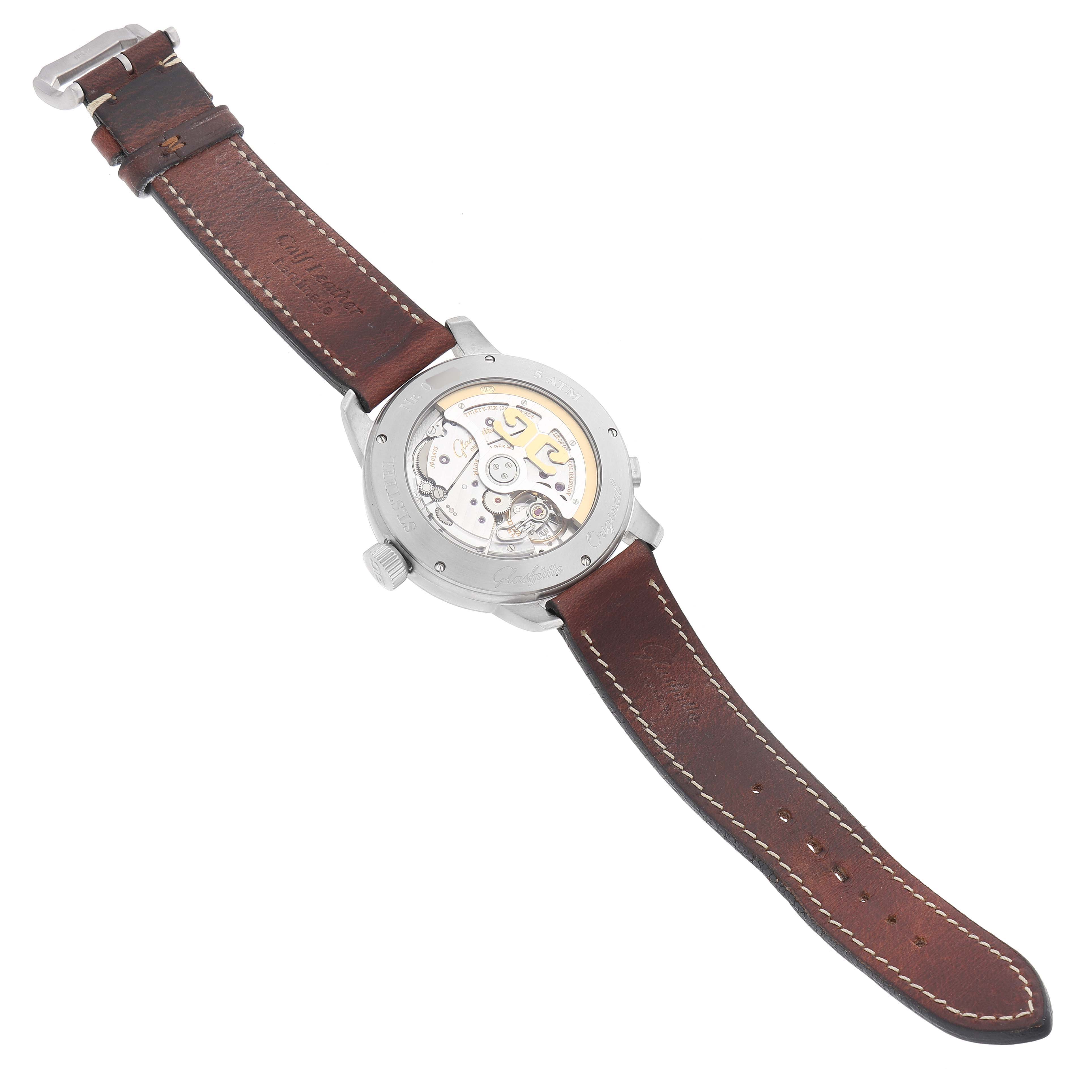 The image shows the back view of the Glashütte Senator watch, highlighting its exposed mechanical movement and leather strap.