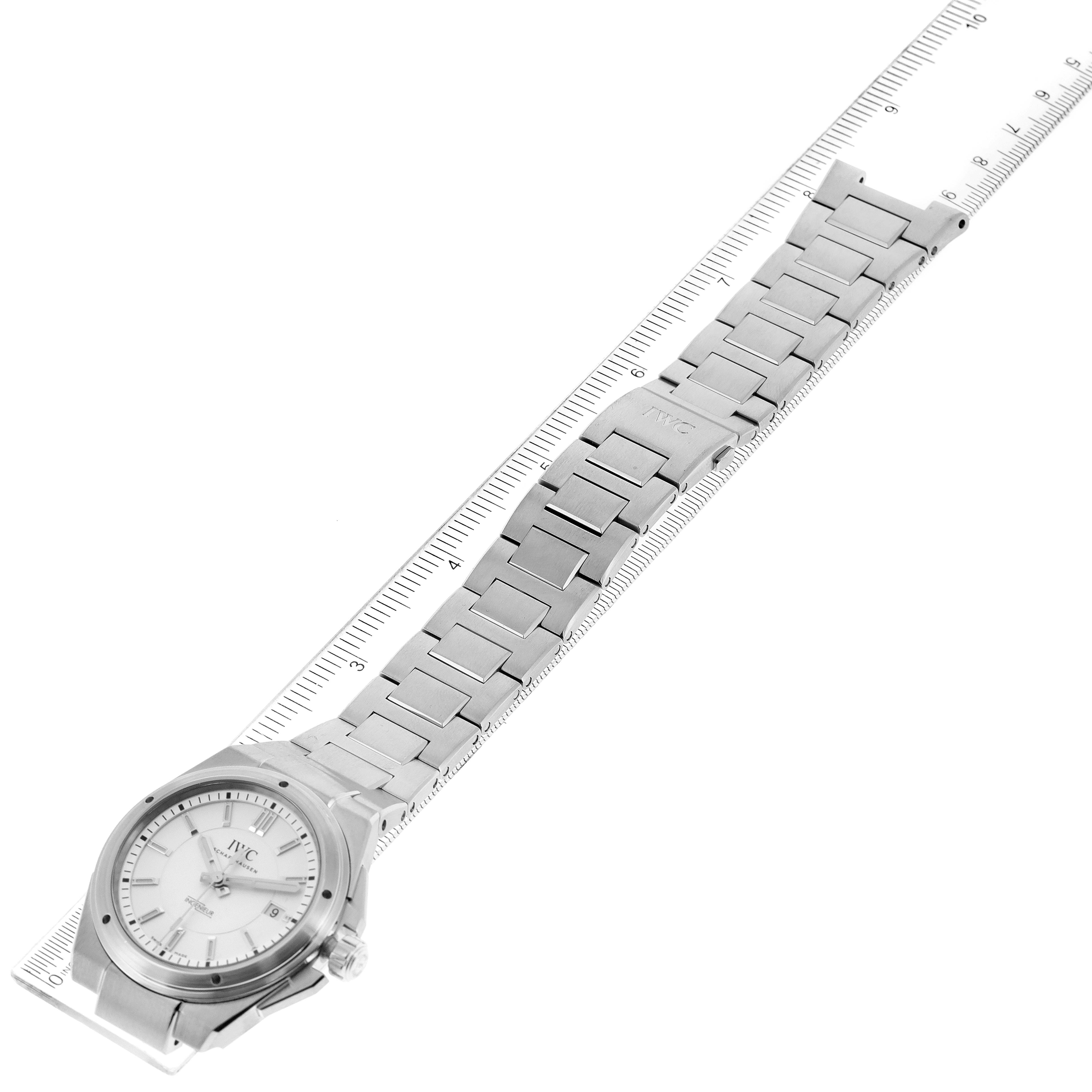 This image shows an IWC Ingenieur IW323904 Men's Stainless Steel Silver Dial IW323904 Men's Stainless Steel Silver Dial watch at a top-down angle, displaying the face and the full length of its metal bracelet next to a ruler.