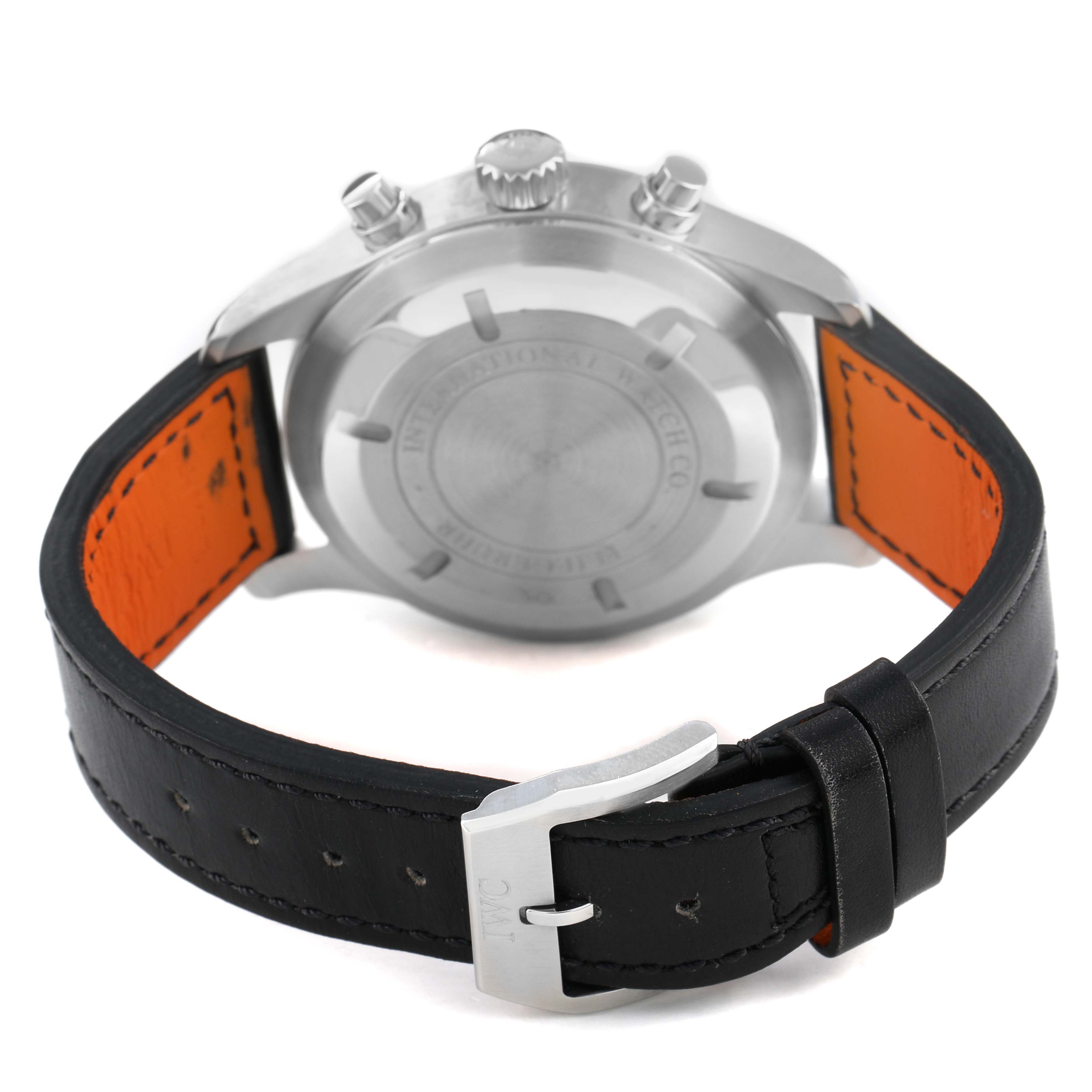 The IWC Pilot IW377701 Men's Stainless Steel Black Dial watch is shown from the back, highlighting the case back, crown, pushers, and leather strap with a buckle.