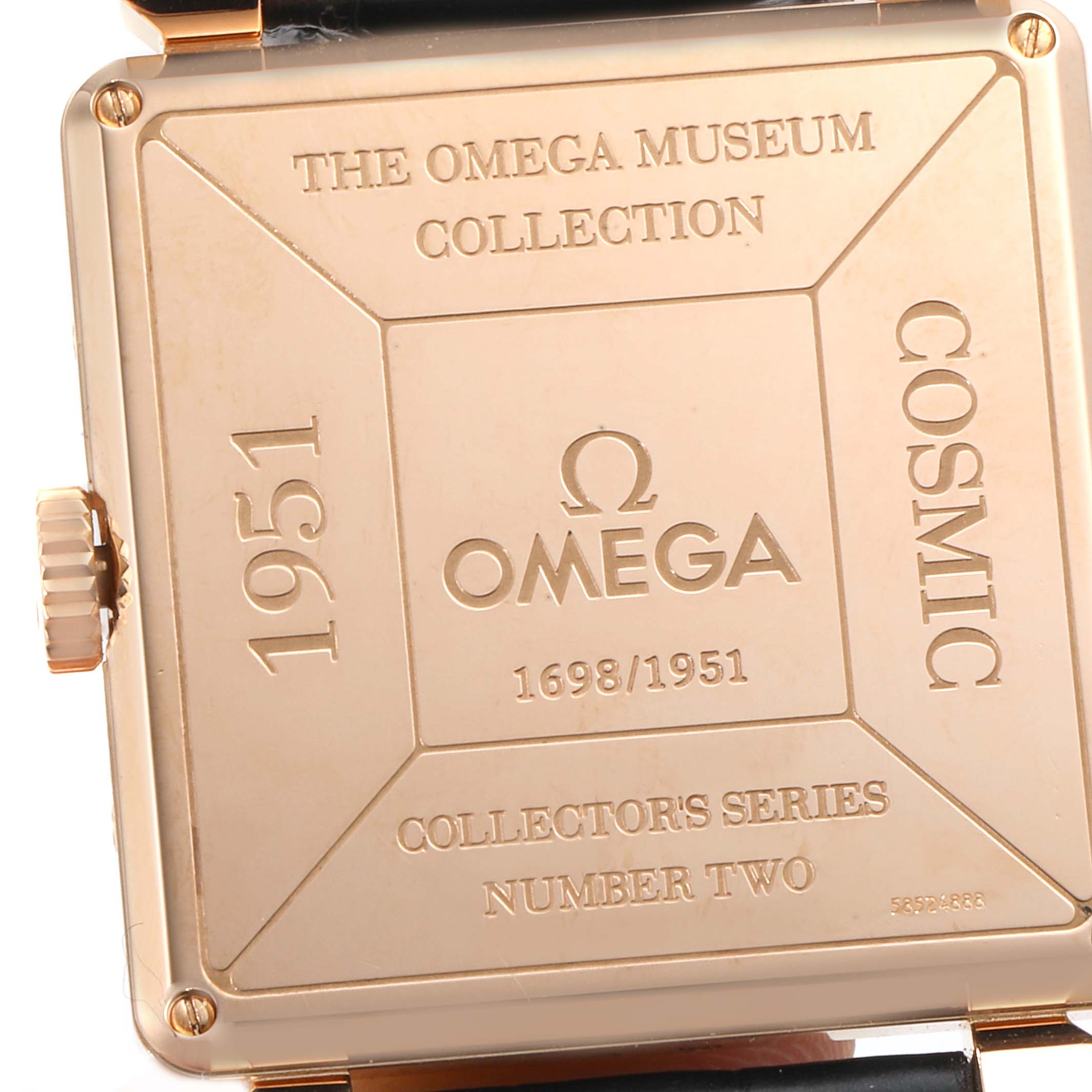 The image shows the back cover of an Omega Museum 5701.80.03 Men's Rose Gold Blue Dial 5701.80.03 Men's Rose Gold Blue Dial Collection watch, specifically the Cosmic 1951 model.