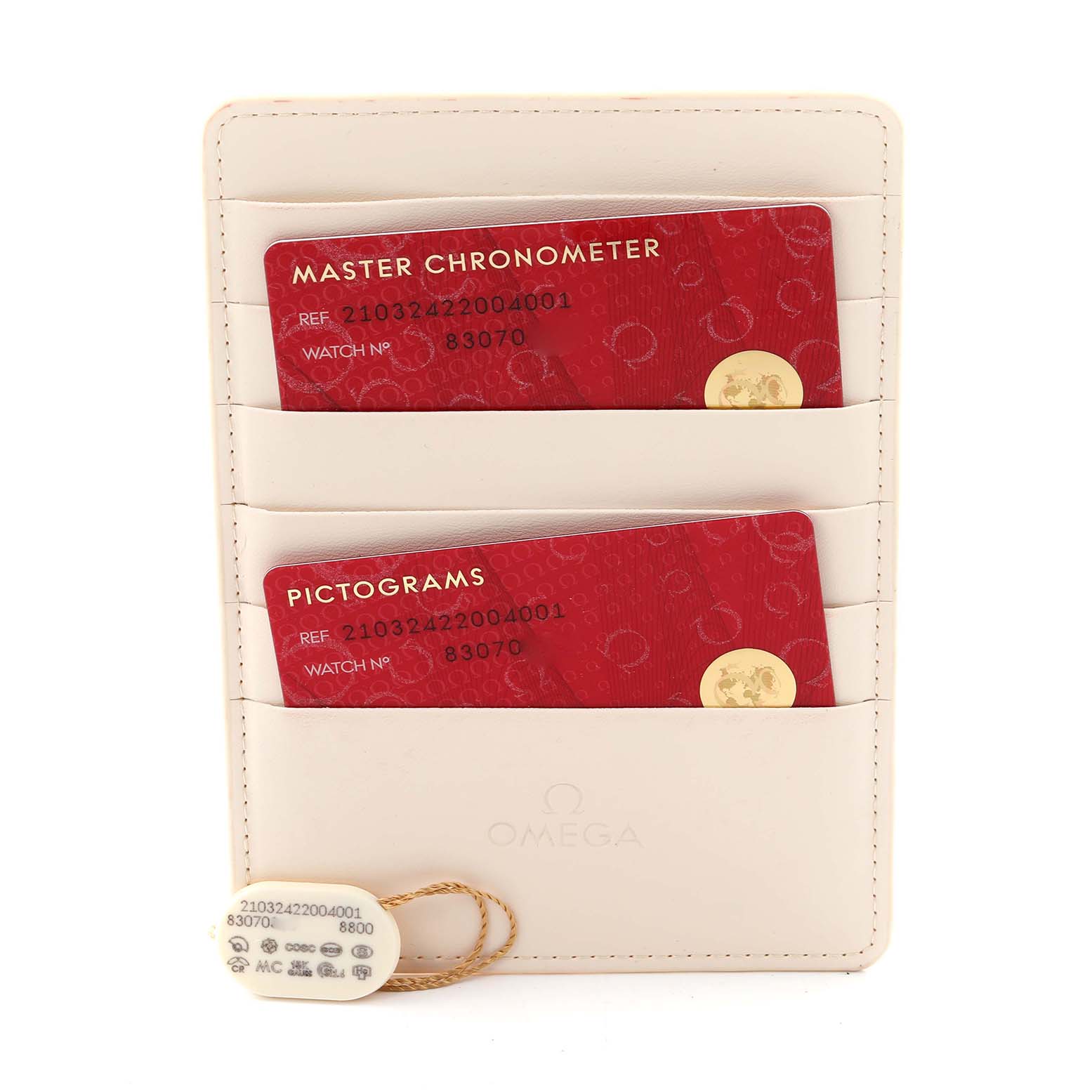 The image shows Omega Seamaster 210.32.42.20.04.001 Men's Stainless Steel White Dial 210.32.42.20.04.001 Men's Stainless Steel White Dial model warranty cards in a cream holder, along with a small tag displaying reference details.