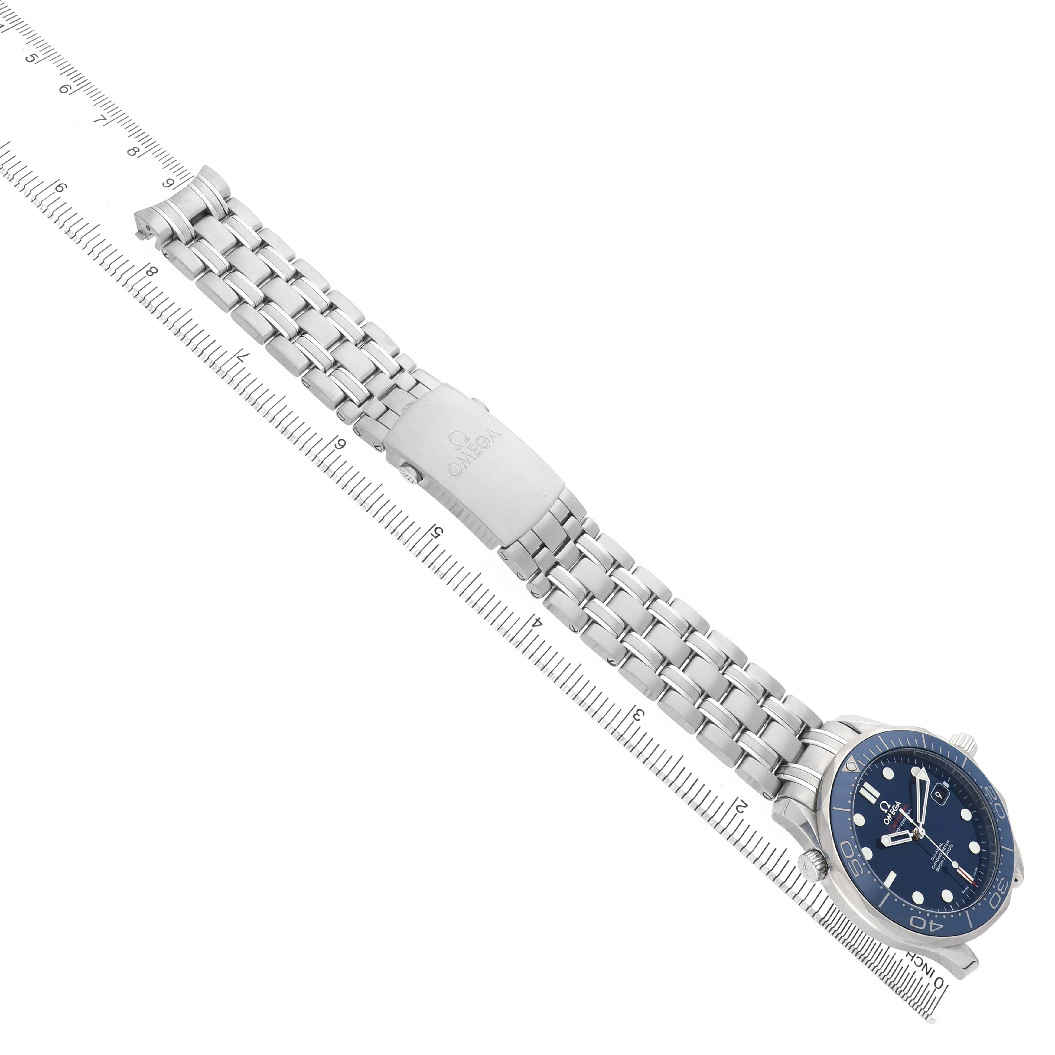 The Omega Seamaster 212.30.41.20.03.001 Men's Stainless Steel Blue Dial watch is shown diagonally with its full metal bracelet and clasp, alongside a measuring scale.