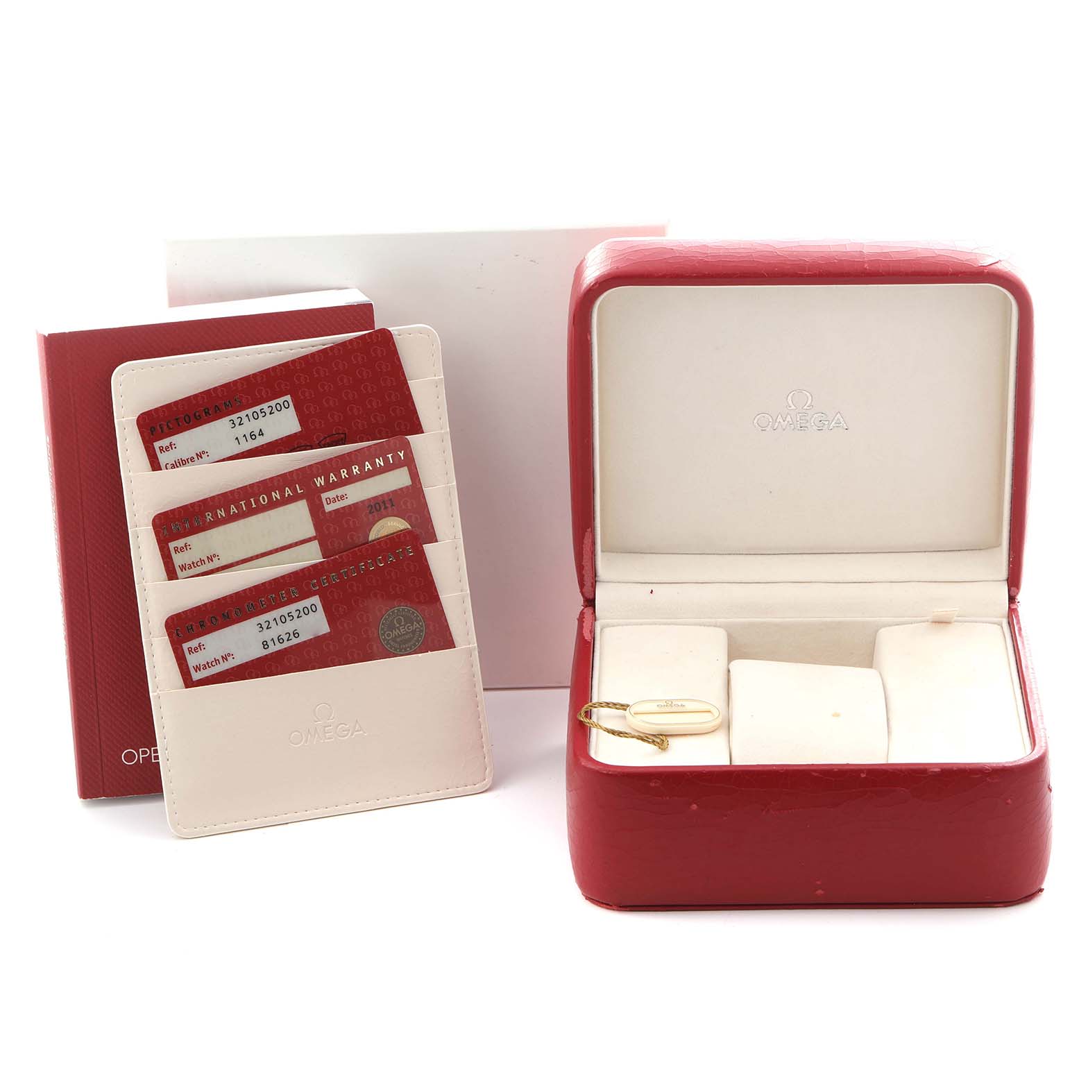 The image shows Omega Speedmaster 3210.52.00 Men
s Stainless Steel Black Dial 3210.52.00 Men
s Stainless Steel Black Dial accessories, including a red watch box, warranty cards, and a tag.