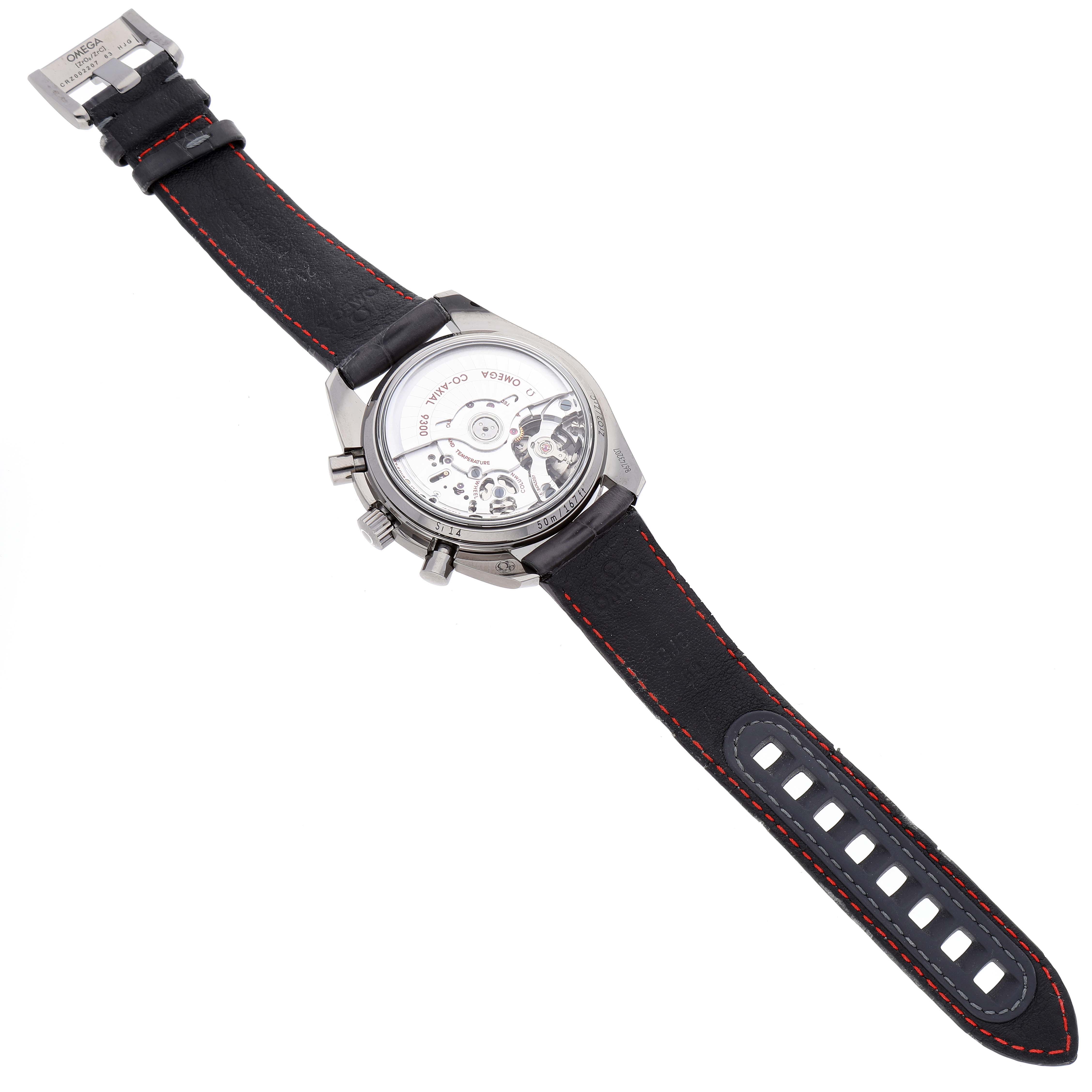 The image shows the back of an Omega Speedmaster 311.93.44.51.99.001 Men's Ceramic Silver Dial 311.93.44.51.99.001 Men's Ceramic Silver Dial watch, highlighting the exposed movement and black strap with red stitching.