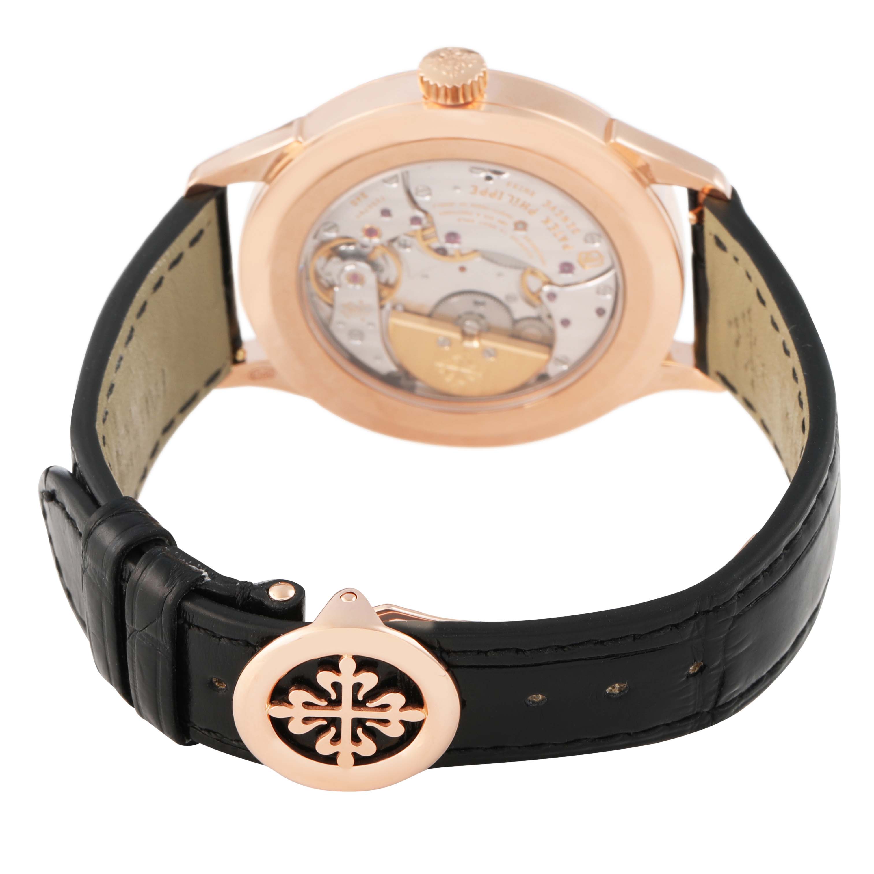 The image shows the back view of a Patek Philippe Complications 5230R-001 Men's Rose Gold Grey Dial watch, highlighting the movement and leather strap with clasp.