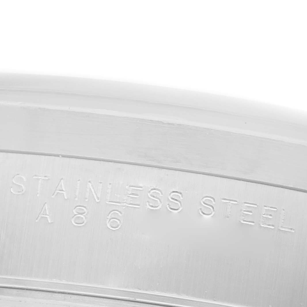 The angle shows a close-up of the back case edge of a Rolex Air-King 14010 Men's Stainless Steel Blue Dial 14010 Men's Stainless Steel Blue Dial watch, featuring "Stainless Steel" engraving.