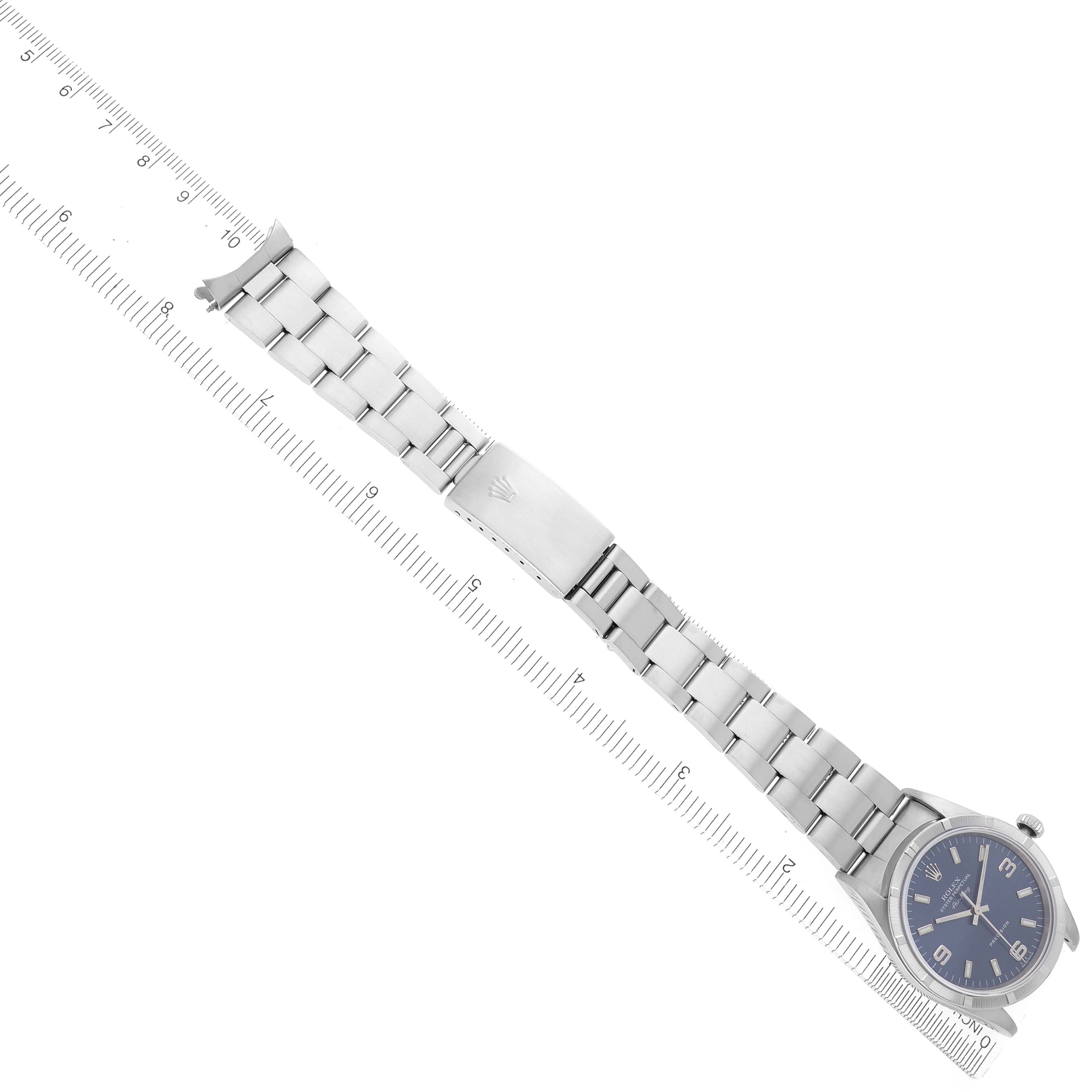 The Rolex Air-King 14010 Men's Stainless Steel Blue Dial 14010 Men's Stainless Steel Blue Dial watch is shown from a top view, displaying the dial, bracelet, and clasp against a ruler for size reference.