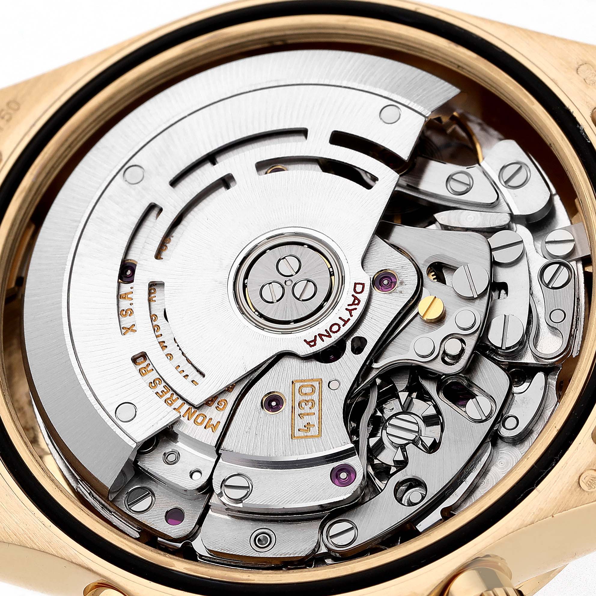 The image shows the Rolex Daytona 116528 Men's Yellow Gold Champagne Dial's intricate movement from the case back, highlighting gears and the rotor.