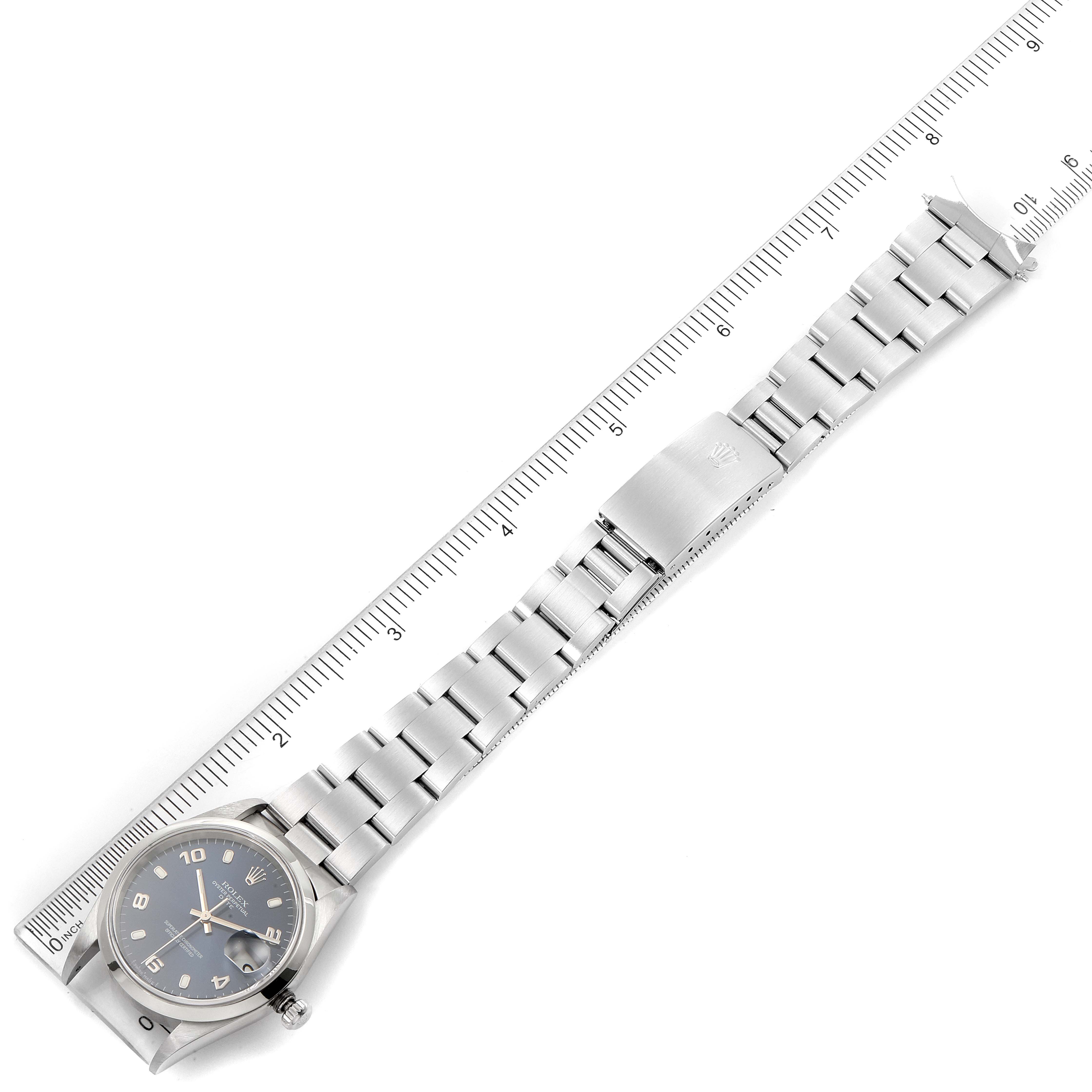 The image shows a Rolex Date 15200 Men's Stainless Steel Blue Dial 15200 Men's Stainless Steel Blue Dial model watch laid flat, aligned with a ruler, displaying its face, bracelet, and clasp.