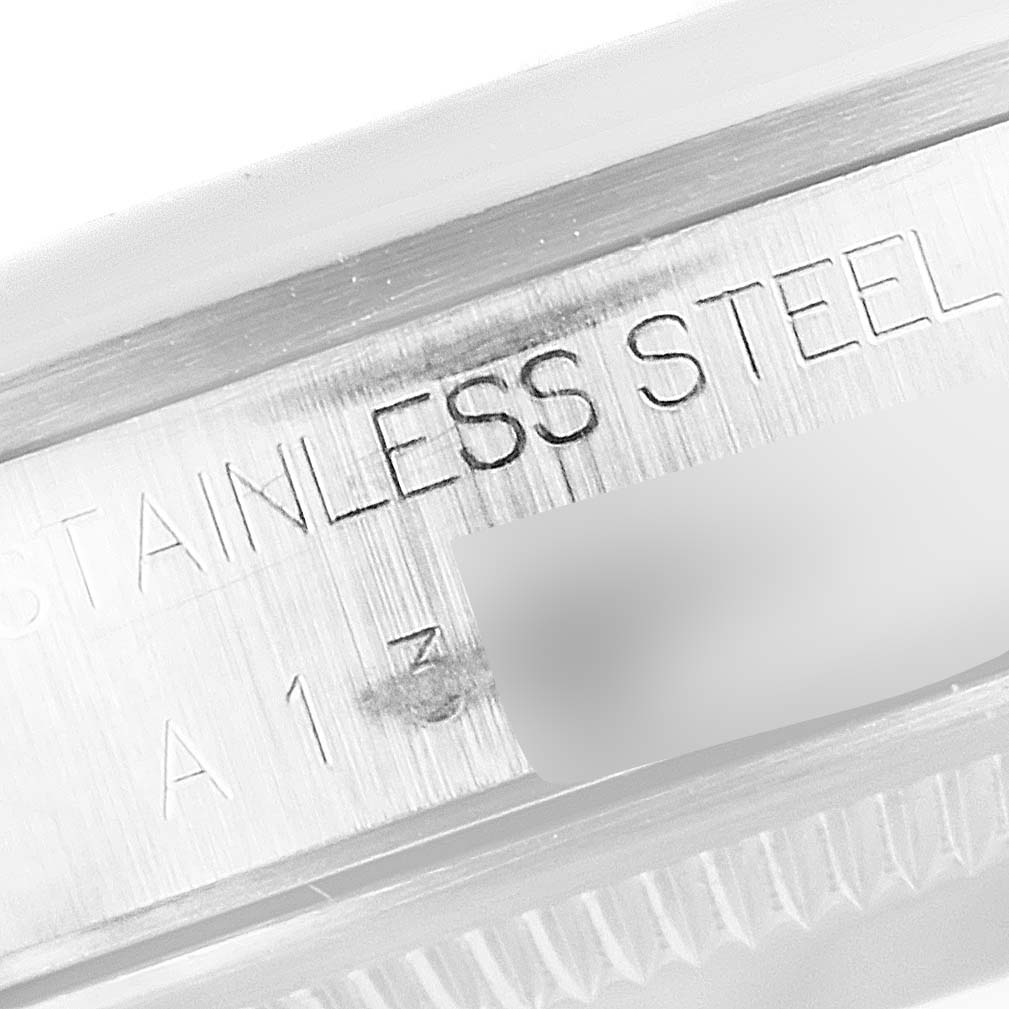 The image shows a close-up view of the stainless steel engraving on the case of a Rolex Date 15200 Men's Stainless Steel Blue Dial 15200 Men's Stainless Steel Blue Dial watch.