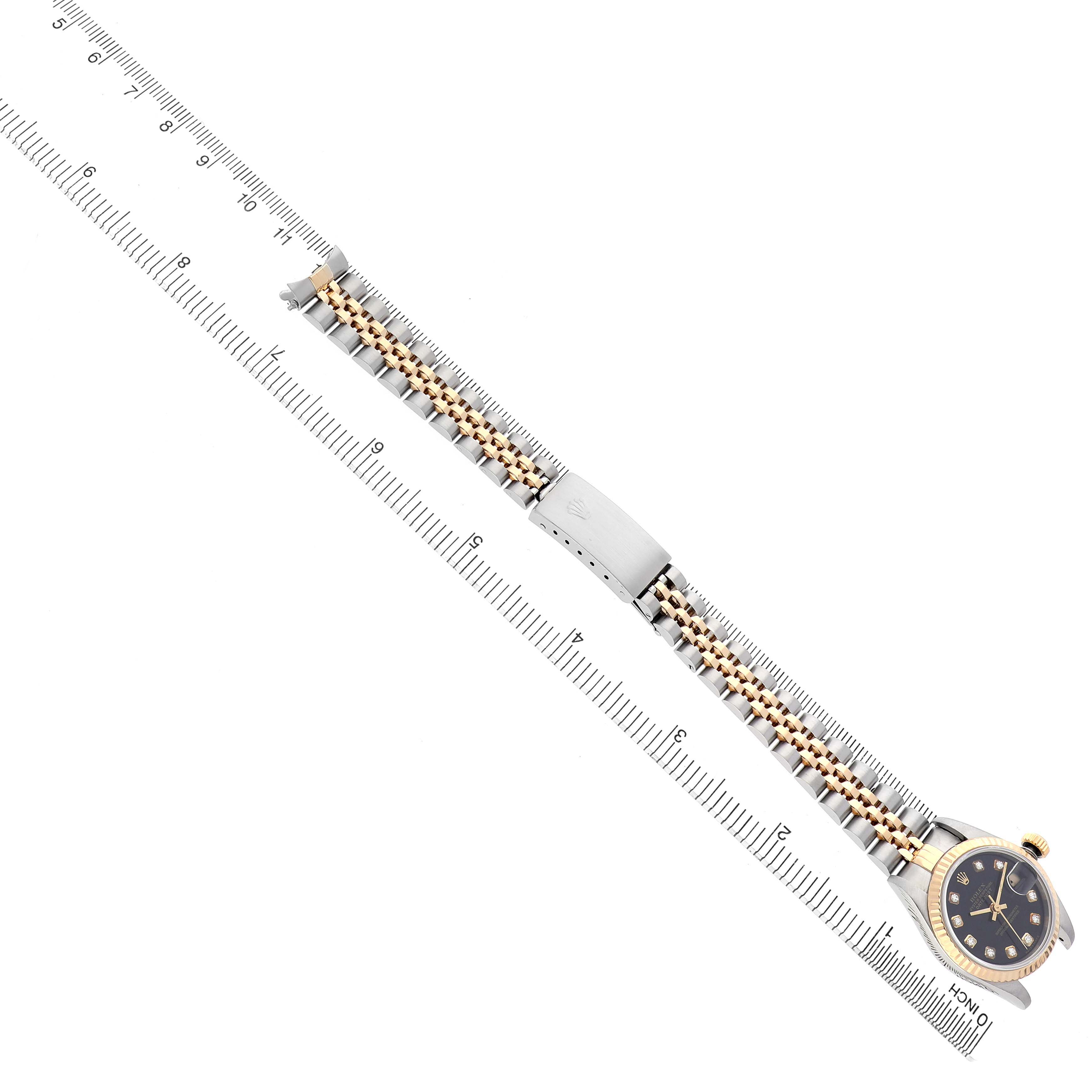 The image shows a top-down view of a Rolex Datejust 79173 Women's Stainless Steel Black Dial watch, highlighting its bracelet and face.