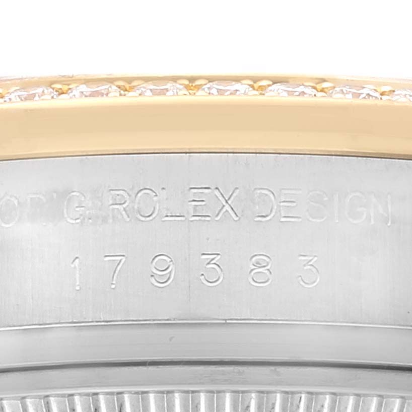 The image shows a close-up view of the side of a Rolex Datejust 179383 Women's Steel and Gold (two tone) Champagne Dial 179383 Women's Steel and Gold (two tone) Champagne Dial watch, focusing on the serial number and part of the bezel.
