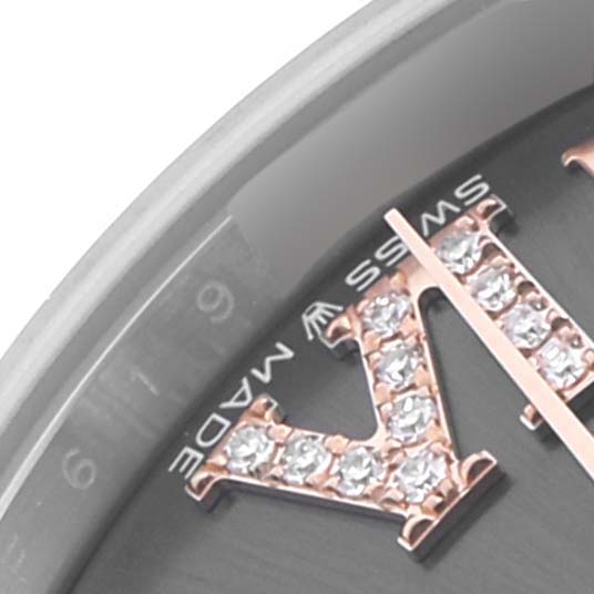 This close-up shows the embellished Roman numeral "VI" of a Rolex Mid-Size 278271 Women's Steel and Gold (two tone) Grey Dial 278271 Women's Steel and Gold (two tone) Grey Dial watch, highlighting gemstones and part of the dial.