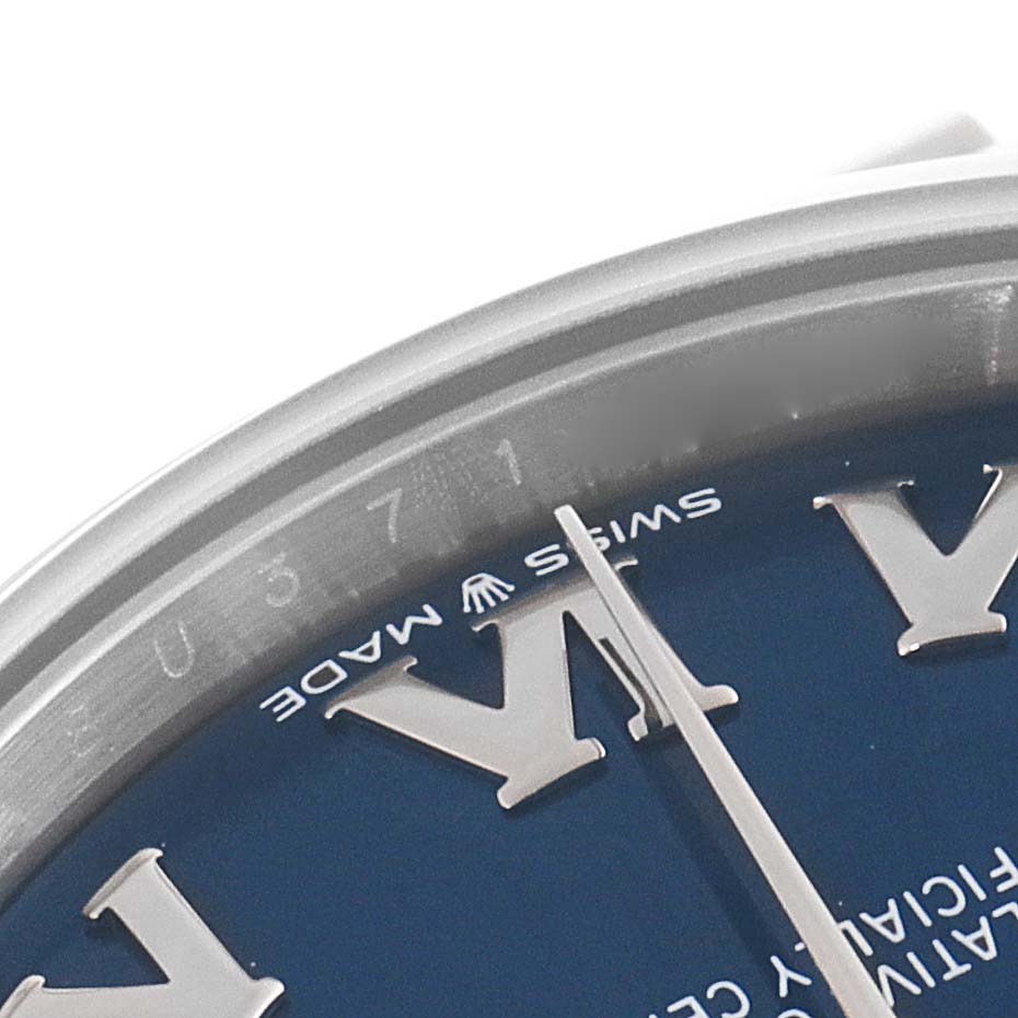 This close-up image shows the "Swiss Made" label and part of the dial and bezel of a Mid-Size Rolex watch.