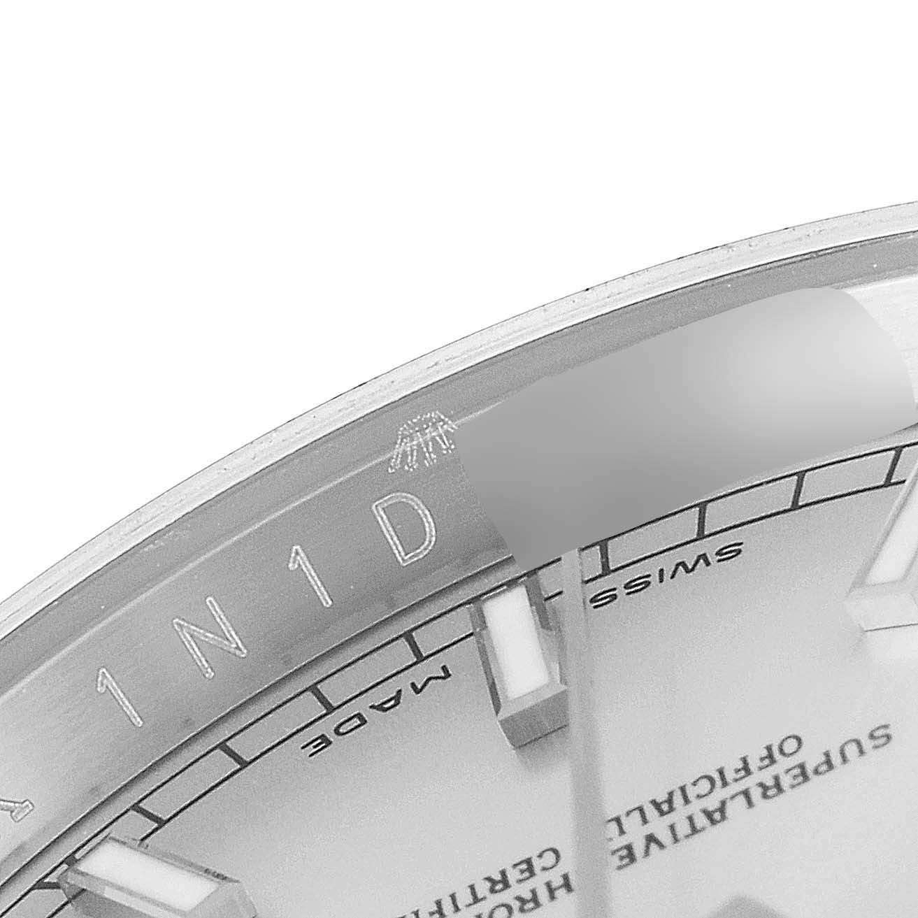 This close-up image of a Rolex Datejust 116200 Men's Stainless Steel Silver Dial 116200 Men's Stainless Steel Silver Dial watch shows part of the dial, markers, and a portion of the rehaut.