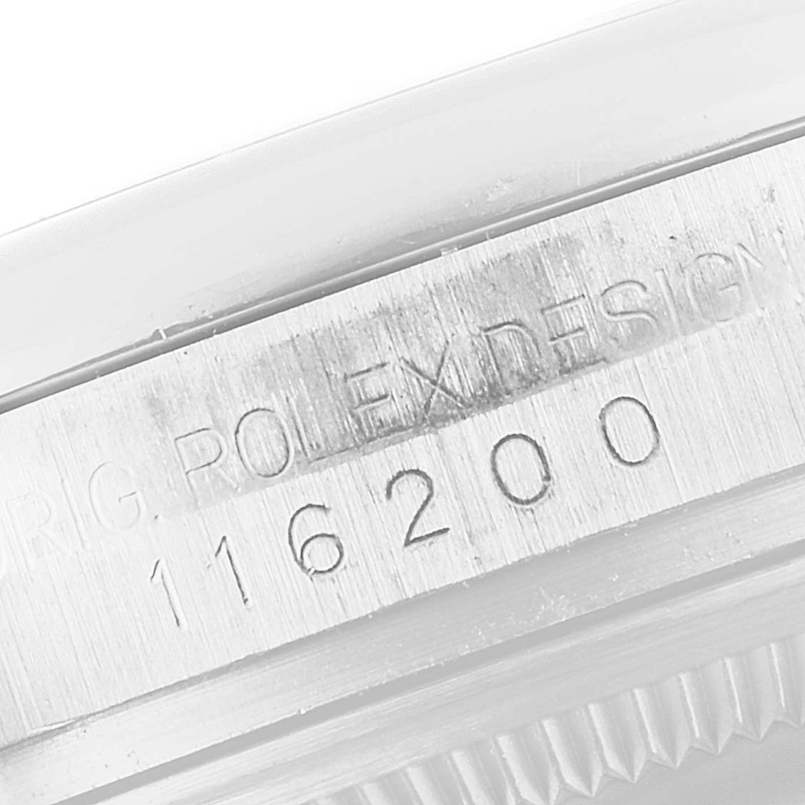 The image shows a close-up of the case side, including the serial number engraving on a Rolex Datejust 116200 Men's Stainless Steel Silver Dial 116200 Men's Stainless Steel Silver Dial watch.