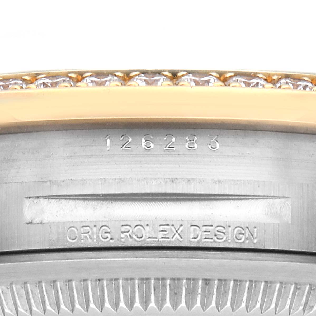 The image shows a close-up of the bezel and case side of the Rolex Datejust 126283RBR Men's Steel and Gold (two tone) Champagne Dial 126283RBR Men's Steel and Gold (two tone) Champagne Dial with engraved markings.