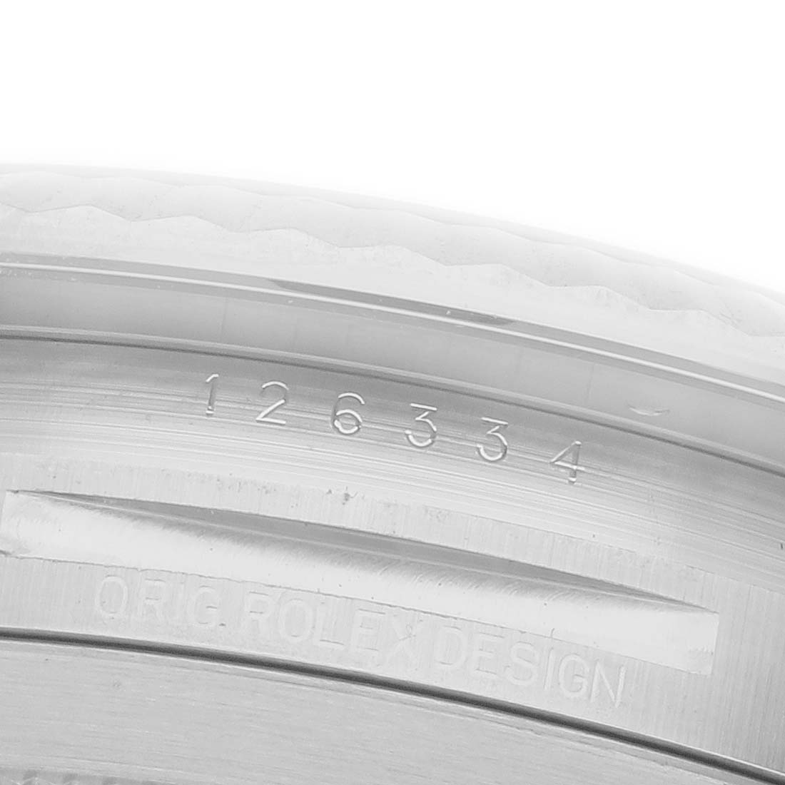 This image shows a close-up of the engraving on the inner case of a Rolex Datejust 41 126334 Men
s Stainless Steel Grey Dial 126334 Men
s Stainless Steel Grey Dial, displaying the model number and "ORIG ROLEX DESIGN."