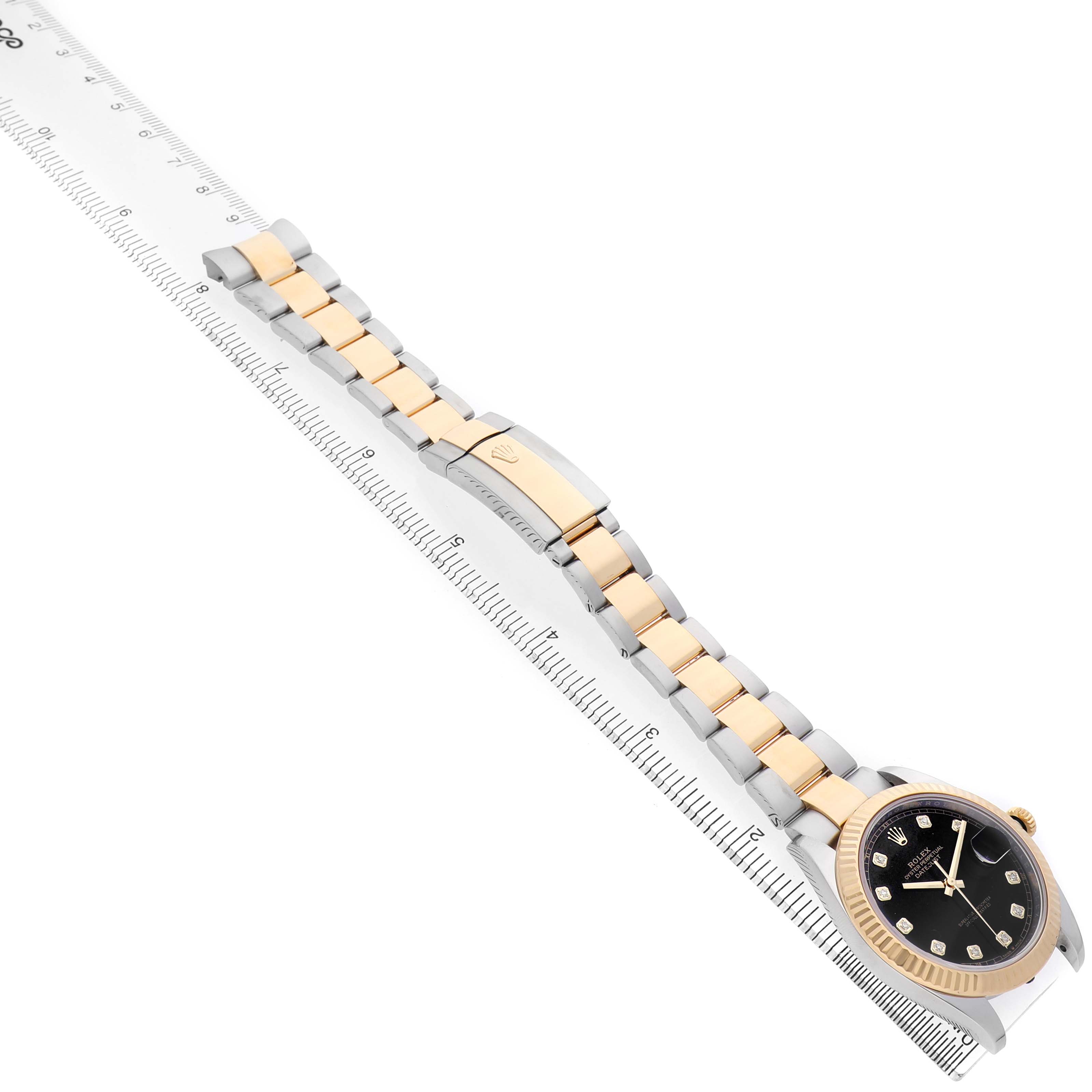 The Rolex Datejust 41 126333 Men's Steel and Gold (two tone) Black Dial is shown at a slight angle, displaying the full bracelet, clasp, and part of the face with a ruler for scale.