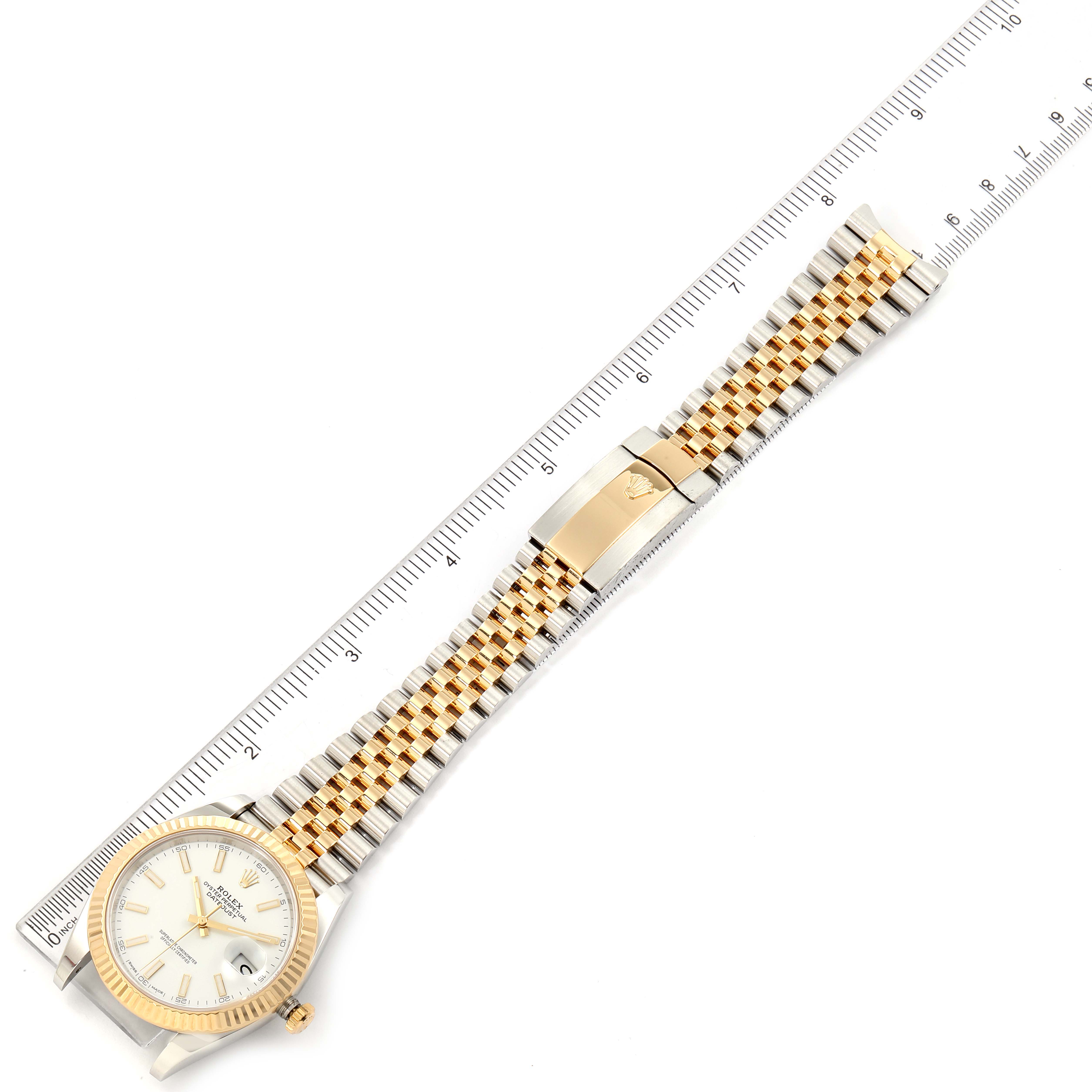 The image shows a top view of a Rolex Datejust 41 126333 Men's Steel and Gold (two tone) White Dial 126333 Men's Steel and Gold (two tone) White Dial watch with a two-tone bracelet and a ruler for scale.
