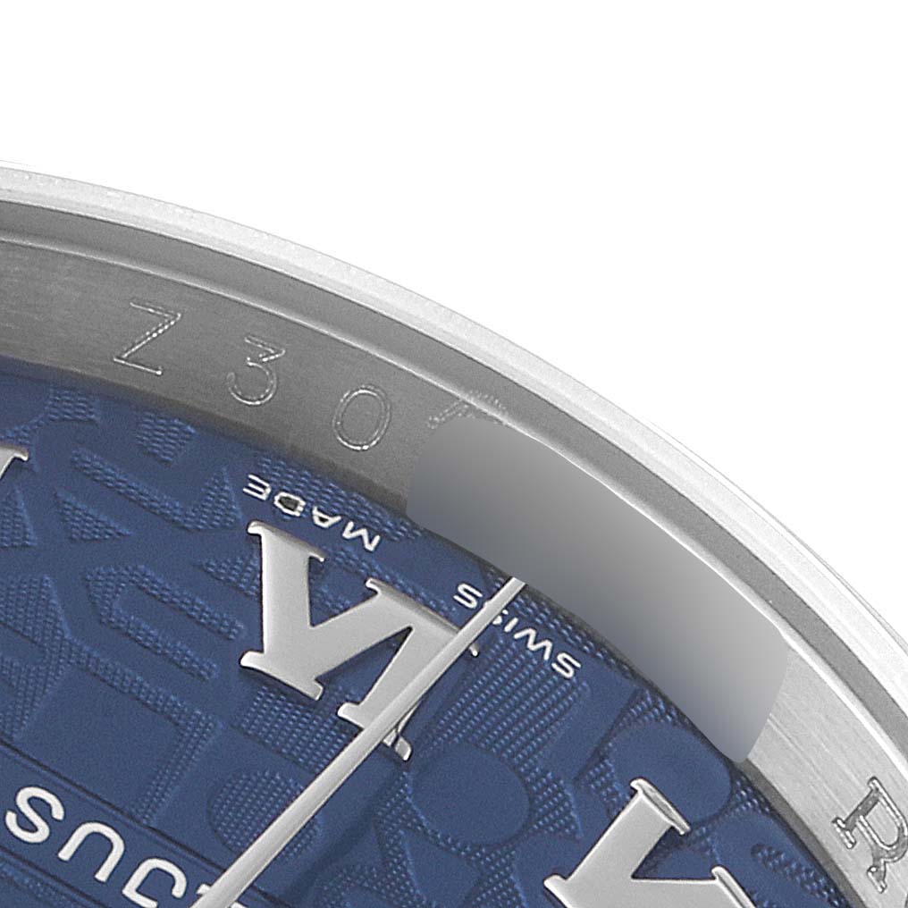This is a close-up of the dial and inner bezel of the Rolex Datejust 116200 Men's Stainless Steel Blue Dial 116200 Men's Stainless Steel Blue Dial watch, showing part of the hour markers and inscriptions.