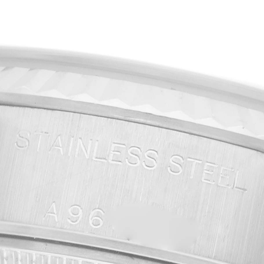 The image shows a close-up of the case side of a Rolex Datejust 79174 Women's Stainless Steel Blue Dial 79174 Women's Stainless Steel Blue Dial, highlighting the "STAINLESS STEEL" engraving.