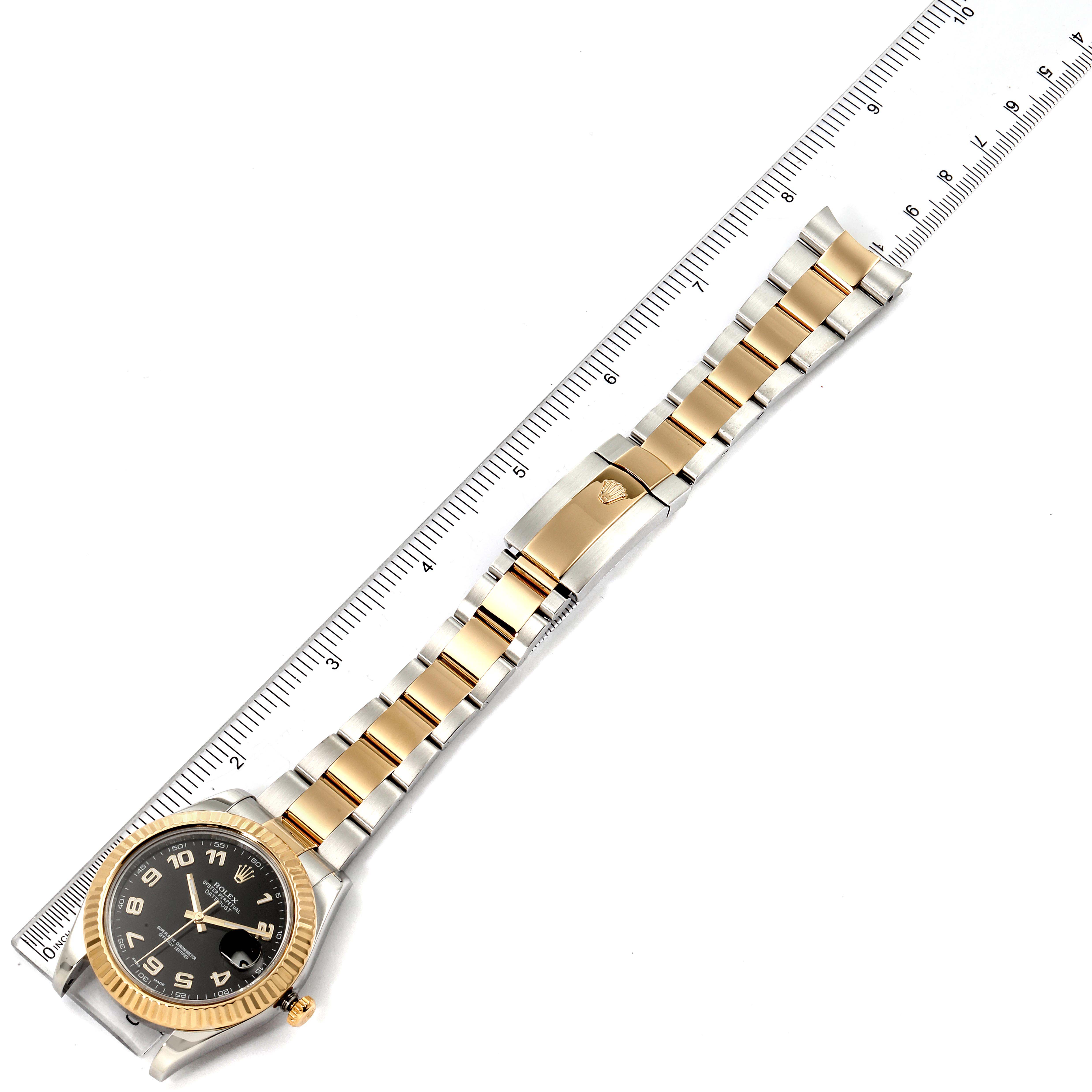 The image shows an overhead view of a Rolex Datejust 41 116333 Men's Steel and Gold (two tone) Black Dial 116333 Men's Steel and Gold (two tone) Black Dial watch, featuring a two-tone bracelet, clasp, and black dial, alongside a ruler for scale.