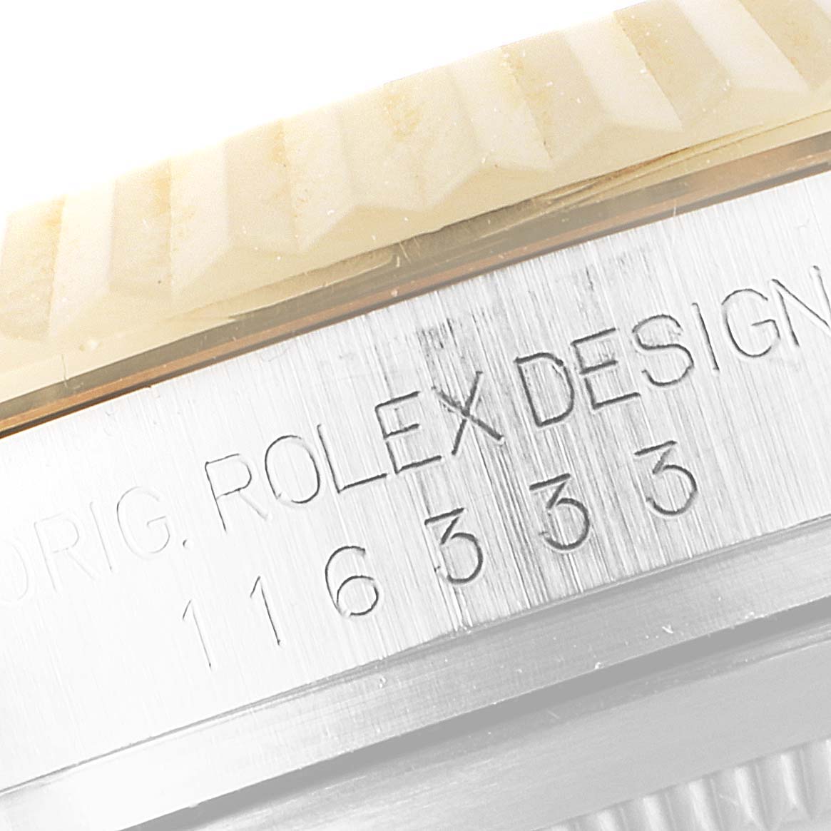 The image shows a close-up view of the Rolex Datejust 41 116333 Men's Steel and Gold (two tone) Silver Dial 116333 Men's Steel and Gold (two tone) Silver Dial model, highlighting the fluted bezel and engraved serial numbers.