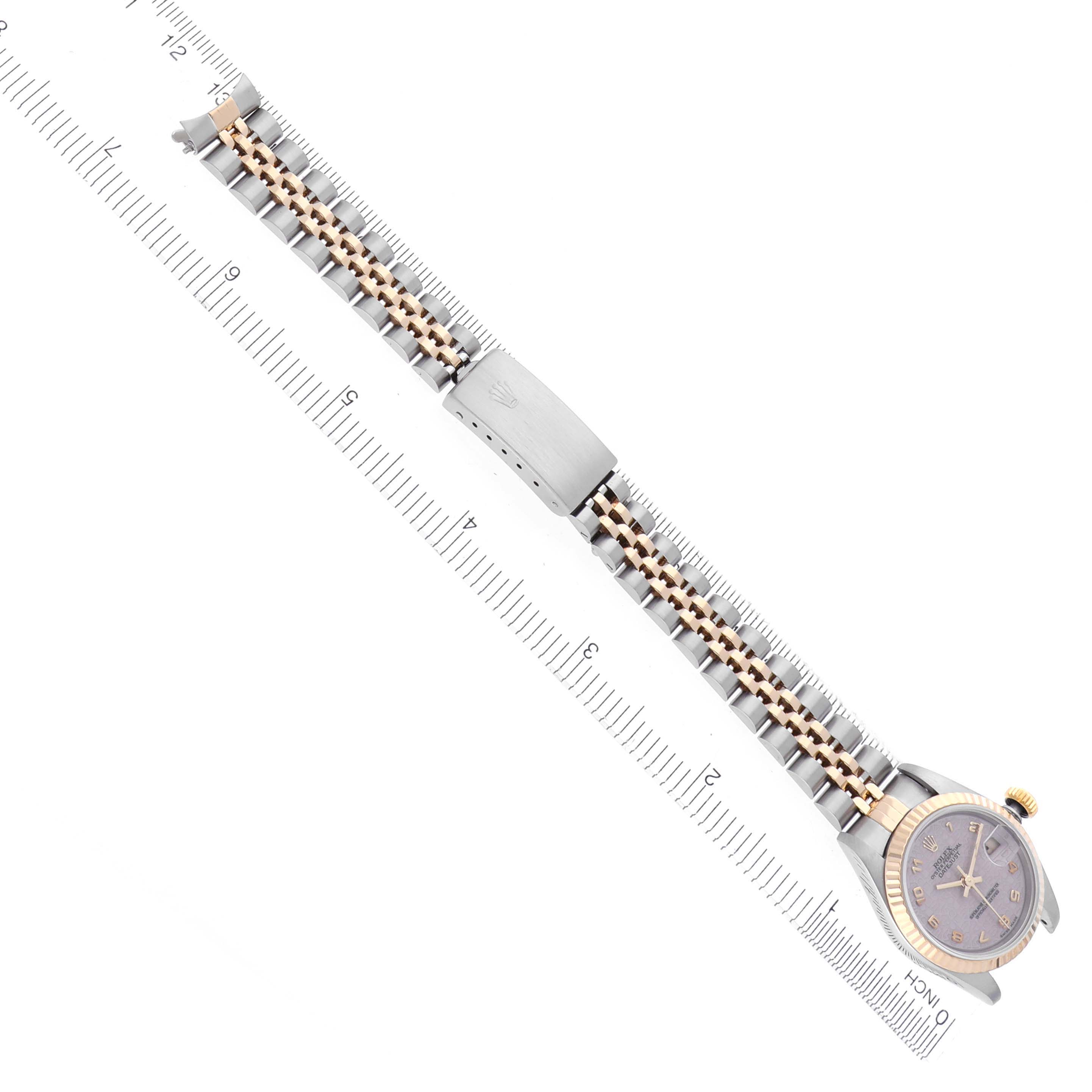 The Rolex Datejust 69173 Women's Steel and Gold (two tone) White Dial 69173 Women's Steel and Gold (two tone) White Dial watch is photographed from above, showing the full bracelet and face next to a measuring ruler.