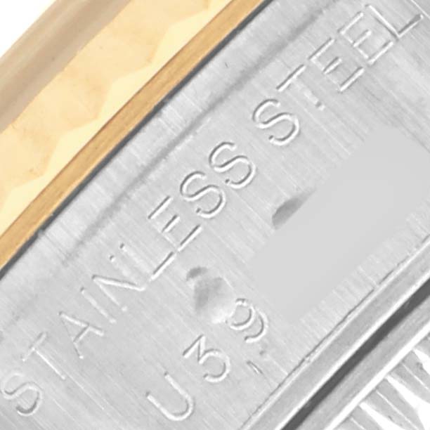 The image shows a close-up of a Rolex Datejust 69173 Women's Steel and Gold (two tone) White Dial 69173 Women's Steel and Gold (two tone) White Dial watch's serial engraving on its stainless steel portion.