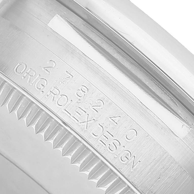 The image shows a close-up of the engraved bezel edge on a Rolex Datejust 278240 Women's Stainless Steel White Dial watch.