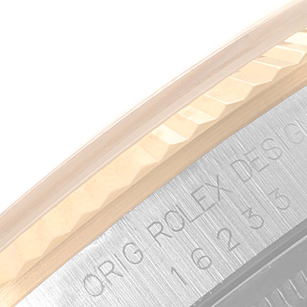 The image shows a close-up of the edge and inscription on the bezel of a Rolex Datejust 16233 Men's Steel and Gold (two tone) Champagne Dial 16233 Men's Steel and Gold (two tone) Champagne Dial watch.