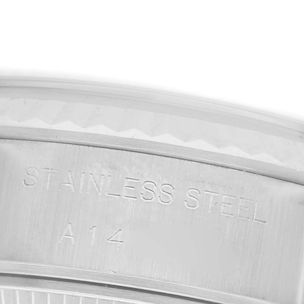 The image shows a close-up of the side of a Rolex Datejust 69174 Women's Stainless Steel Blue Dial 69174 Women's Stainless Steel Blue Dial watch, highlighting the "Stainless Steel" engraving.