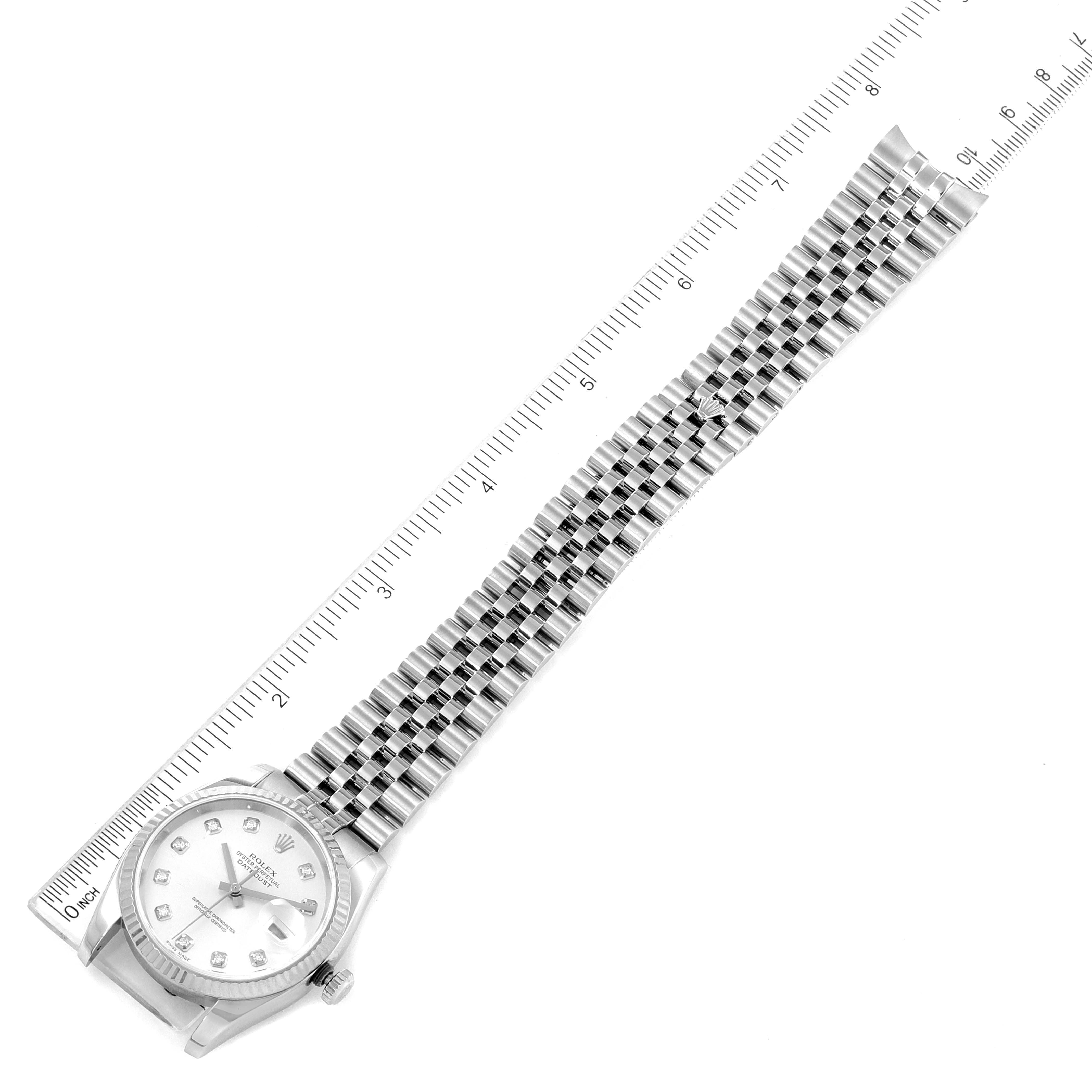 The Rolex Datejust 116234 Men's Stainless Steel Silver Dial 116234 Men's Stainless Steel Silver Dial watch is shown from a top-down angle, displaying its face and entire bracelet against a ruler for scale.