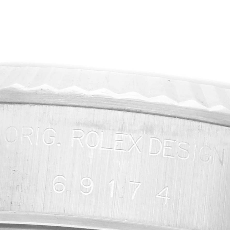 The image shows a close-up of the case side of a Rolex Datejust 69174 Women's Stainless Steel Silver Dial 69174 Women's Stainless Steel Silver Dial, highlighting the engraving.
