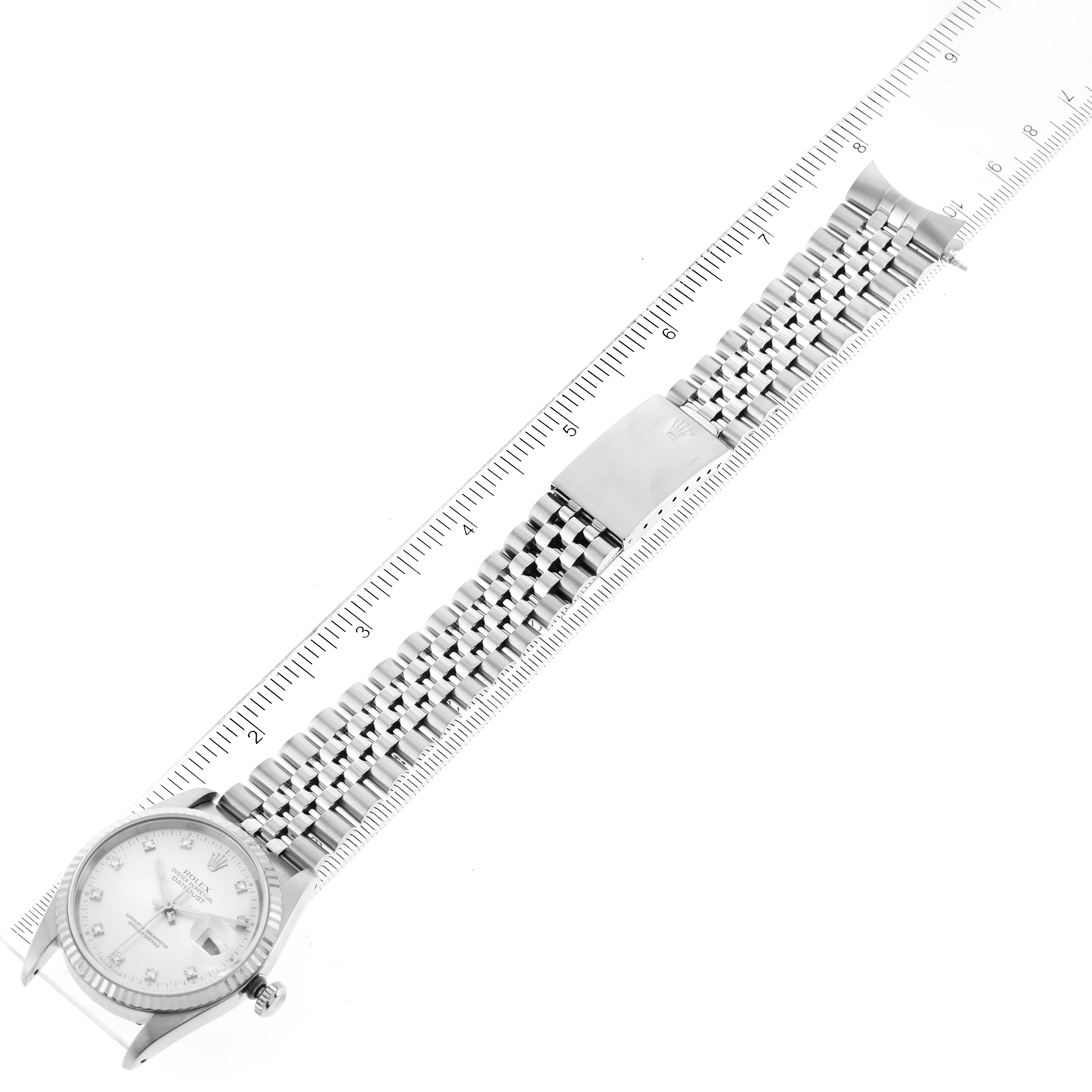 The image shows a top-down view of a Rolex Datejust 16234 Men's Stainless Steel Silver Dial 16234 Men's Stainless Steel Silver Dial watch, including the face, bezel, bracelet, and clasp, placed alongside a ruler.