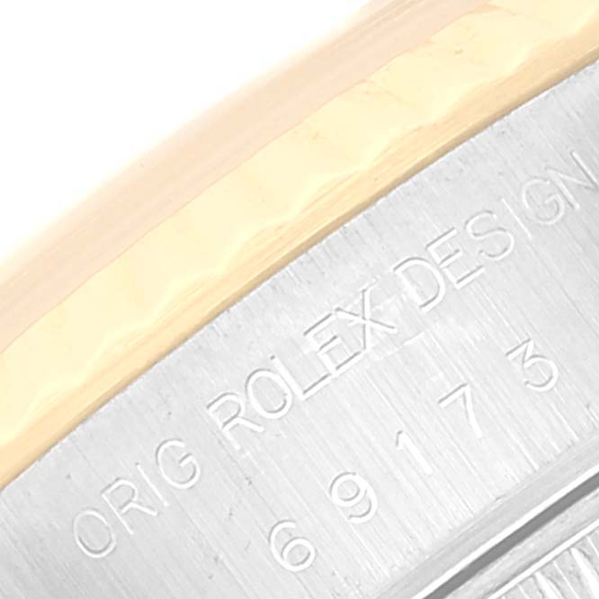 The image shows a close-up of the engraving on the side of the Rolex Datejust 69173 Women's Steel and Gold (two tone) Beige Dial 69173 Women's Steel and Gold (two tone) Beige Dial watch bezel.