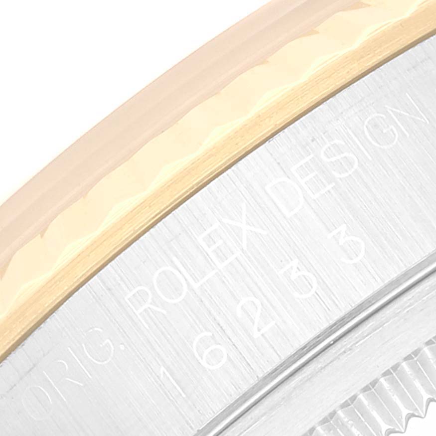 This close-up angle shows part of the bezel and side engraving of the Rolex Datejust 16233 Men's Steel and Gold (two tone) Champagne Dial 16233 Men's Steel and Gold (two tone) Champagne Dial model.
