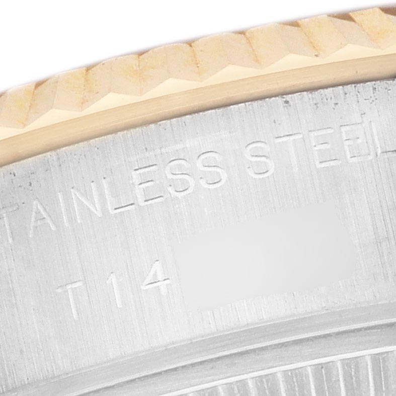 The image shows a close-up of the Rolex Datejust 69173 Women's Steel and Gold (two tone) Champagne Dial 69173 Women's Steel and Gold (two tone) Champagne Dial's steel case back and fluted bezel edge.