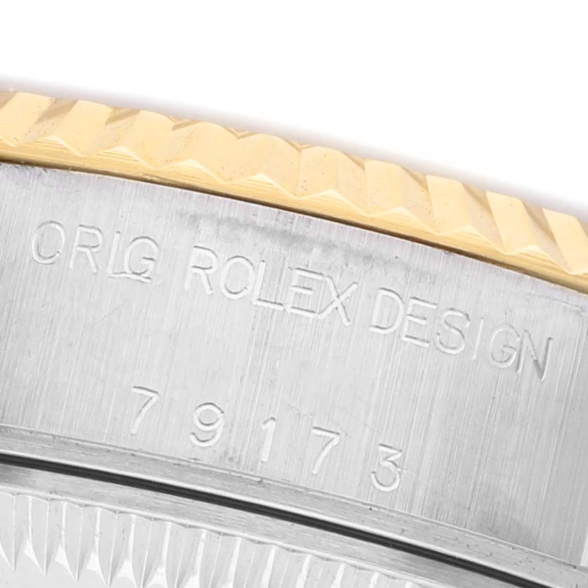 This image shows a close-up of the side of a Rolex Datejust 79173 Women's Steel and Gold (two tone) Champagne Dial, highlighting the model number and Rolex design engraving.