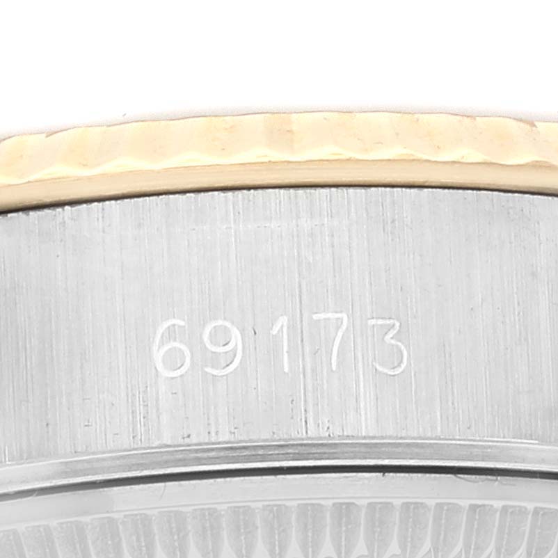This close-up image shows the serial number and part of the bezel of the Rolex Datejust 69173 Women's Steel and Gold (two tone) Champagne Dial 69173 Women's Steel and Gold (two tone) Champagne Dial watch.