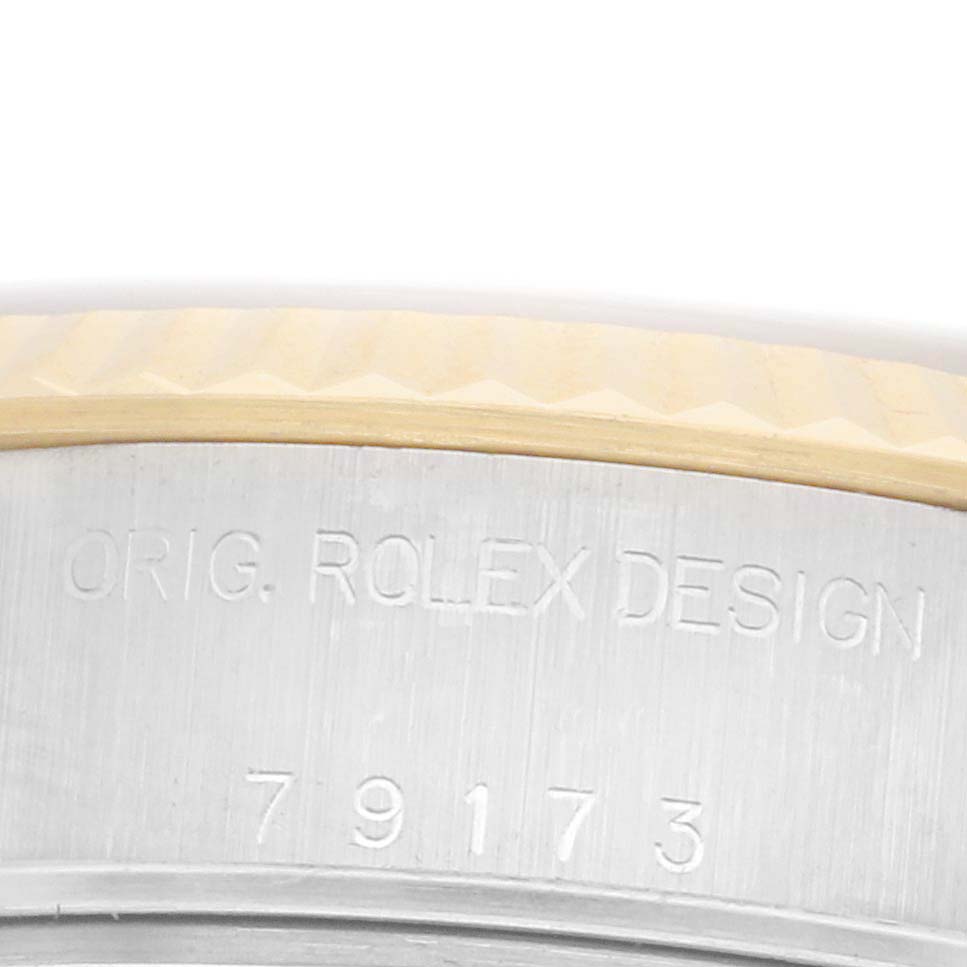The image shows a close-up of the Rolex Datejust 79173 Women's Steel and Gold (two tone) Silver Dial 79173 Women's Steel and Gold (two tone) Silver Dial case with "ORIG. ROLEX DESIGN" and the reference number 79173 engraved.