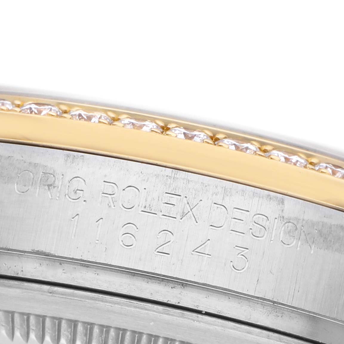 The image shows a close-up of the Rolex Datejust 116243 Men's Steel and Gold (two tone) Mother of Pearl Dial model's bezel with diamonds and engraved serial number.