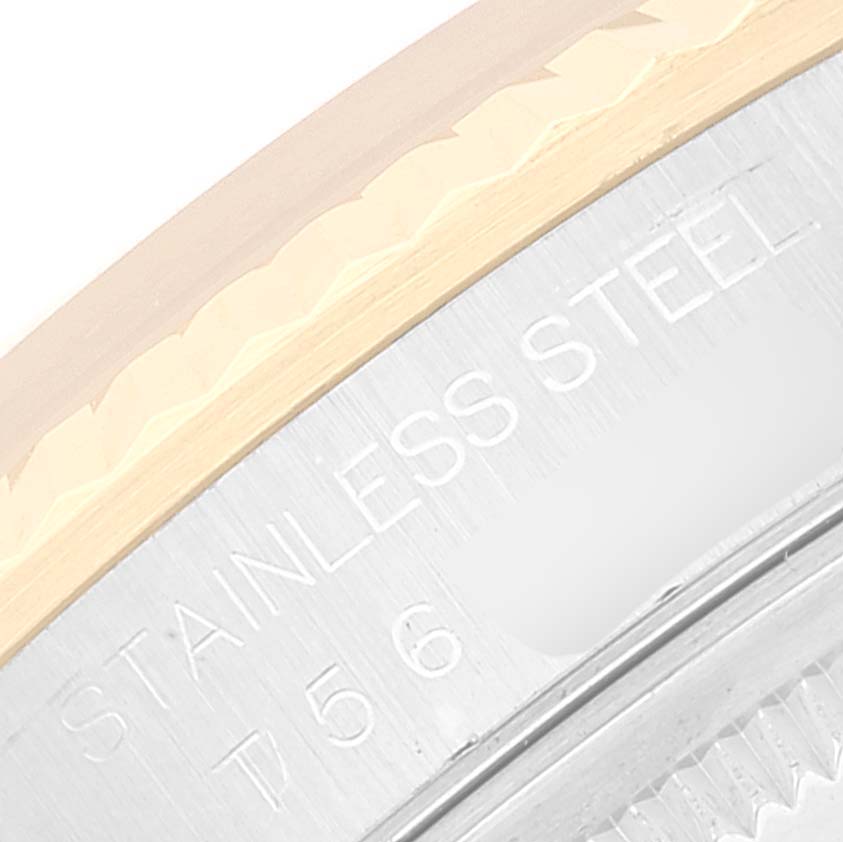 This close-up image shows the stainless steel and gold bezel of a Rolex Datejust 16233 Men's Steel and Gold (two tone) Silver Dial 16233 Men's Steel and Gold (two tone) Silver Dial watch, highlighting part of the engraved text.
