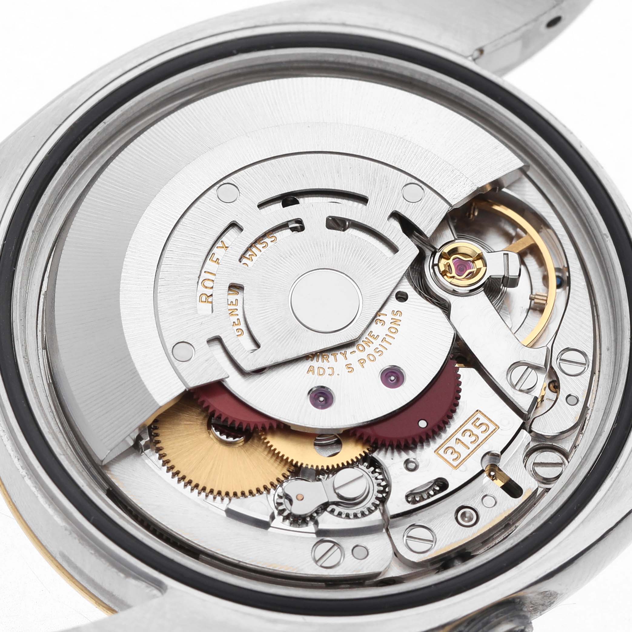 The image shows the movement mechanism of a Rolex Datejust 116233 Men's Stainless Steel Silver Dial watch from a top-down angle, highlighting its intricate gears and rotor.
